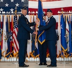 U.S. Air Force Col. Jesse Lamarand, 5th Bomb Wing (BW) outgoing commander, right, relinquishes the guidon to U.S. Air Force Maj. Gen. Ty Neuman, 8th Air Force and Joint-Global Strike Operations Center commander, left, during a change of command ceremony at Minot Air Force Base, North Dakota, July 9, 2026. As the 5th BW commander, Lamarand directed over 6,000 military and civilian personnel across the wing’s four groups, and was responsible for ensuring the combat readiness of the wing's B-52H Stratofortress fleet, providing long-range strike and strategic deterrence capabilities worldwide.(U.S. Air Force photo by Airman 1st class Anthony Ramey)