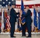 U.S. Air Force Col. Jesse Lamarand, 5th Bomb Wing (BW) outgoing commander, right, relinquishes the guidon to U.S. Air Force Maj. Gen. Ty Neuman, 8th Air Force and Joint-Global Strike Operations Center commander, left, during a change of command ceremony at Minot Air Force Base, North Dakota, July 9, 2026. As the 5th BW commander, Lamarand directed over 6,000 military and civilian personnel across the wing’s four groups, and was responsible for ensuring the combat readiness of the wing's B-52H Stratofortress fleet, providing long-range strike and strategic deterrence capabilities worldwide.(U.S. Air Force photo by Airman 1st class Anthony Ramey)