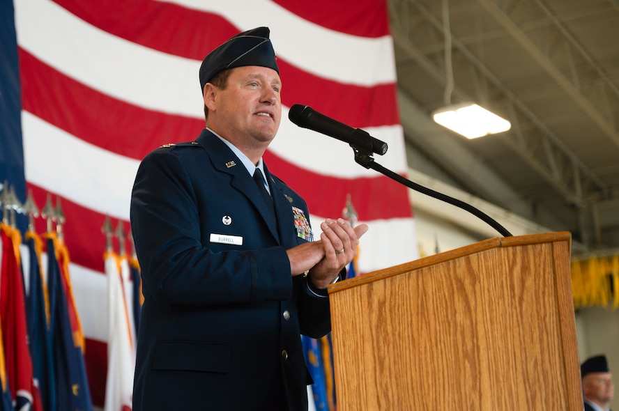 U.S. Air Force Col. John Burrell, 5th Bomb Wing (BW) incoming commander, gives remarks during a change of command ceremony at Minot Air Force Base, North Dakota, July 9, 2026. As the incoming commander, Burrell is responsible for leading the 5th BW’s B-52H Stratofortress operations and ensuring the wing remains ready to provide global strike capabilities in support of Air Force Global Strike Command’s strategic deterrence mission. (U.S. Air Force photo by Airman 1st Class Anthony Ramey)