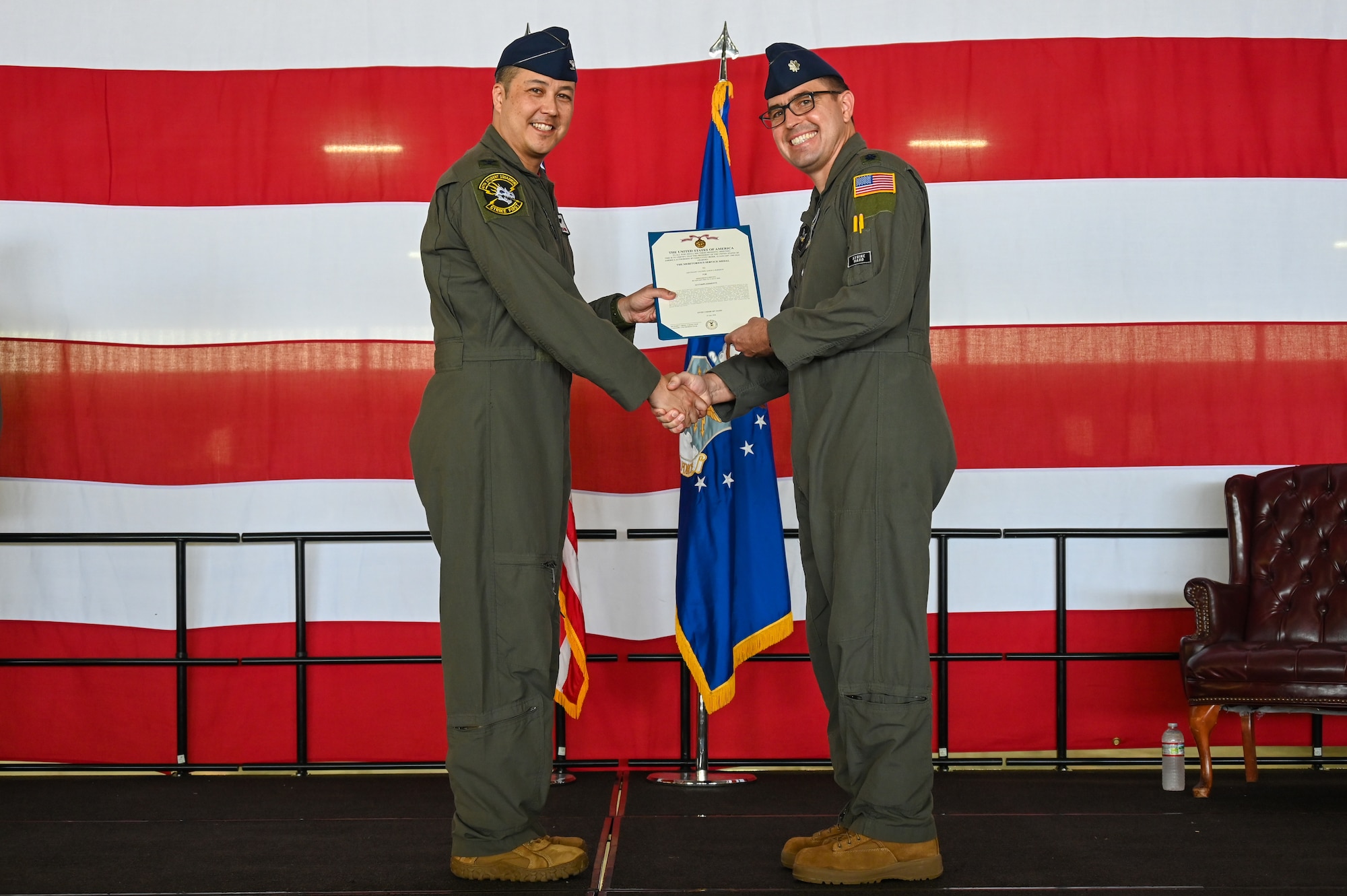 From the left, U.S. Air Force Col. Richard Greig, 47th Operations Group commander, presents the Meritorious Service medal to Lt. Col. Aaron Borszich, 47th Student Squadron (STUS) outgoing commander, during the 47th STUS change of command ceremony at Laughlin Air Force Base, Texas, July 10, 2026. The Meritorious Service Medal is a military award given to members of the United States Armed Forces who distinguish themselves through exceptional meritorious achievement or service to the nation. (U.S. Air Force photo by Airman 1st Class Kylie Rabb)