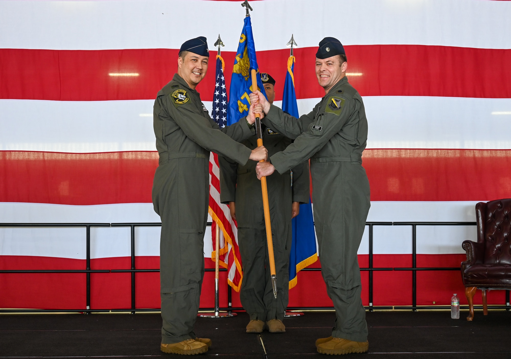 From the left, U.S. Air Force Lt. Col. Dane Coppini, 47th Student Squadron (STUS) incoming commander, is presenteds the 47th STUS guidon from Col. Richard Greig, 47th Operations Group commander, during the 47th STUS change of command ceremony at Laughlin Air Force Base, Texas, July 10, 2026. Change of command ceremonies represent a formal transfer of authority and responsibility of a unit from one commanding officer to another. (U.S. Air Force photo by Airman 1st Class Kylie Rabb)
