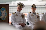 Capt. Stanley Fields, the outgoing Coast Guard Sector Southeast Alaska commander, left, and Capt. Ginny Nadolny, the incoming sector commander, right, sit during a change of command ceremony at Coast Guard Station Juneau, Alaska, July 10, 2026.