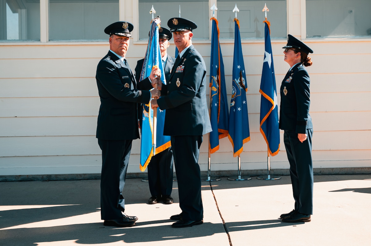 U.S. Air Force Gen. S.L. Davis, commander of Air Force Global Strike Command, passes the 20th Air Force Guidon to Maj. Gen. Colin Connor, incoming 20th AF commander at the 20th AF change of command at F.E. Warren Air Force Base, Cheyenne, Wyoming, July 10, 2026. Prior to taking command of 20th AF, Connor served as the Director of Intercontinental Ballistic Missile Modernization, Site Activation Task Force, Barksdale Air Force Base, Louisiana. (U.S. Air Force photo by Senior Airman Mattison Cole)