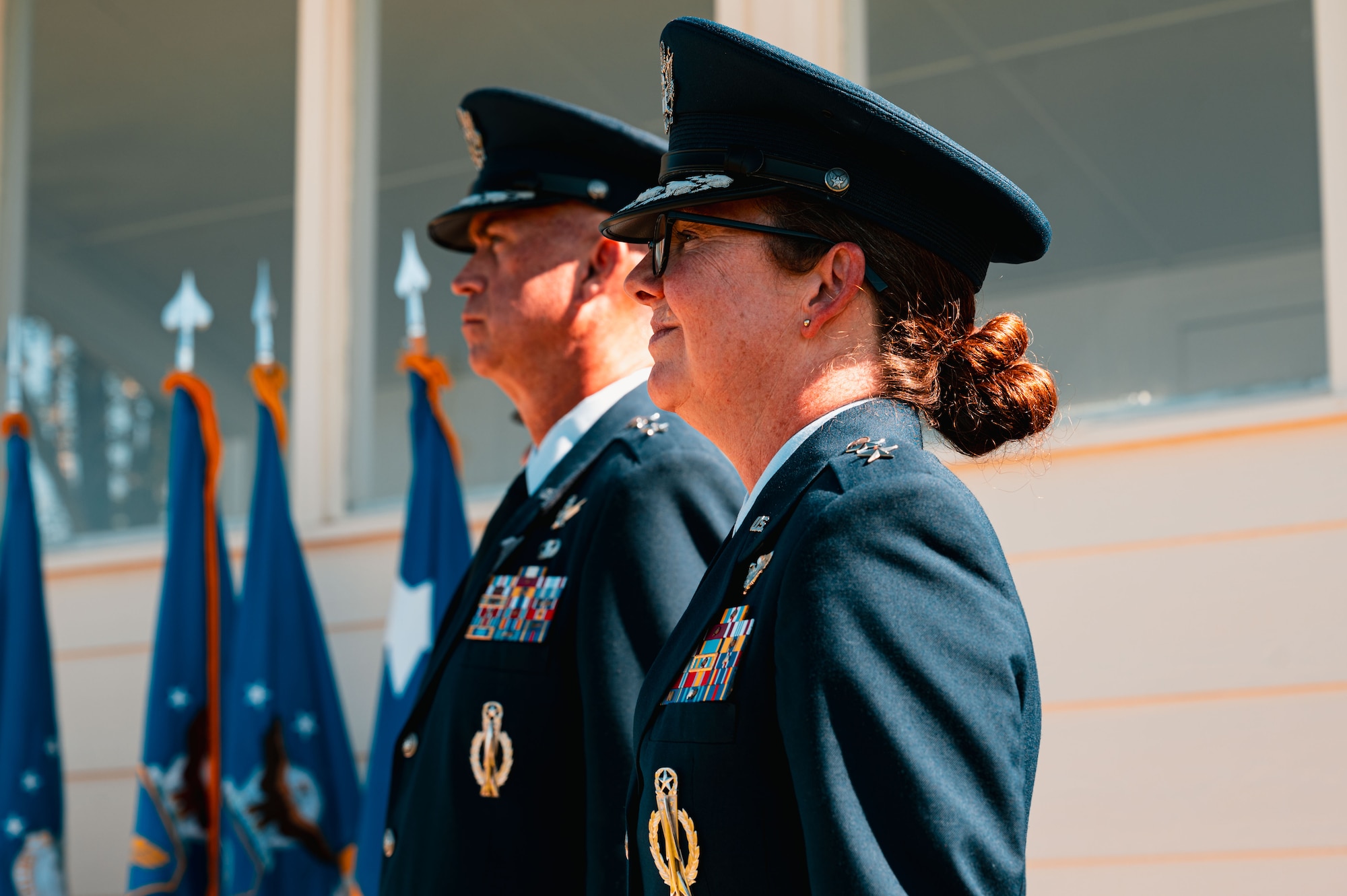 Maj. Gen. Stacy Jo Huser, outgoing 20th Air Force commander, and Maj. Gen. Colin Connor, incoming 20th AF commander, prepare to pass the guidon during the 20th AF change of command at F.E. Warren Air Force Base, Cheyenne, Wyoming, July 10, 2026. The change of command ceremony formally transferred leadership and responsibility of the Numbered Air Force from the outgoing commander to the incoming commander while honoring the unit's continued commitment to mission success.(U.S. Air Force photo by Senior Airman Mattison Cole)