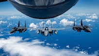 U.S. Air Force aircraft including an F-15EX Eagle II, center, and two F-15E Strike Eagles assigned to the 85th Test and Evaluation Squadron fly in formation after receiving fuel from a KC-135 Stratotanker assigned to the 909th Air Refueling Squadron over the Pacific Ocean, June 29, 2026. The aircraft flew to Kadena Air Base, Japan, for integration and familiarization training with local units and joint partners in preparation for the permanent arrival of the F-15EX. (U.S. Air Force photo by Airman 1st Class Arnet Tamayo)