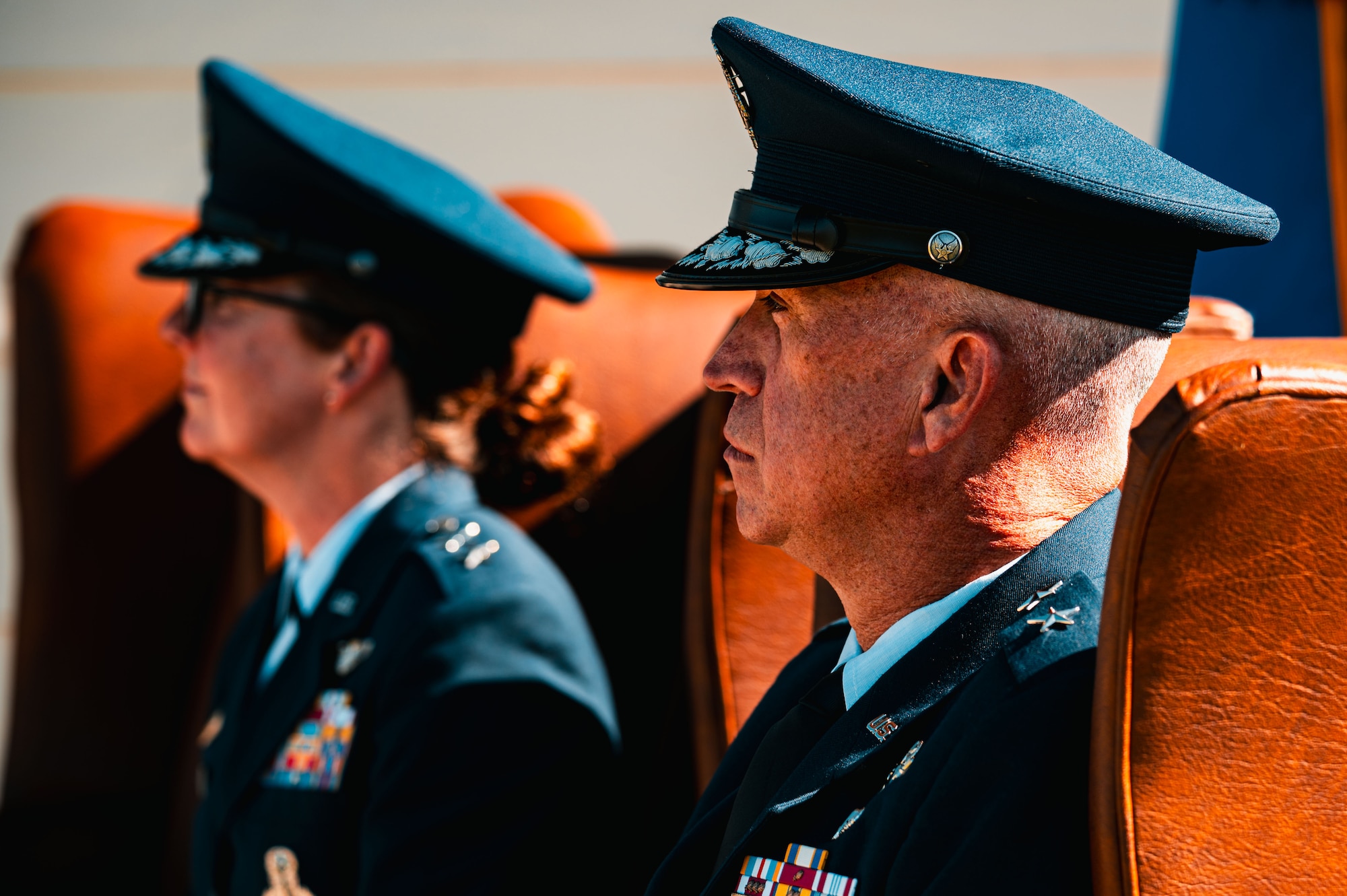 Maj. Gen. Stacy Jo Huser, outgoing 20th Air Force commander, and Maj. Gen. Colin Connor, incoming 20th AF commander, listen to remarks from Gen. S.L. Davis during the 20th AF change of command at F.E. Warren Air Force Base, Cheyenne, Wyoming, July 10, 2026. The change of command ceremony formally transferred leadership and responsibility of the Numbered Air Force from the outgoing commander to the incoming commander while honoring the unit's continued commitment to mission success.(U.S. Air Force photo by Senior Airman Mattison Cole)