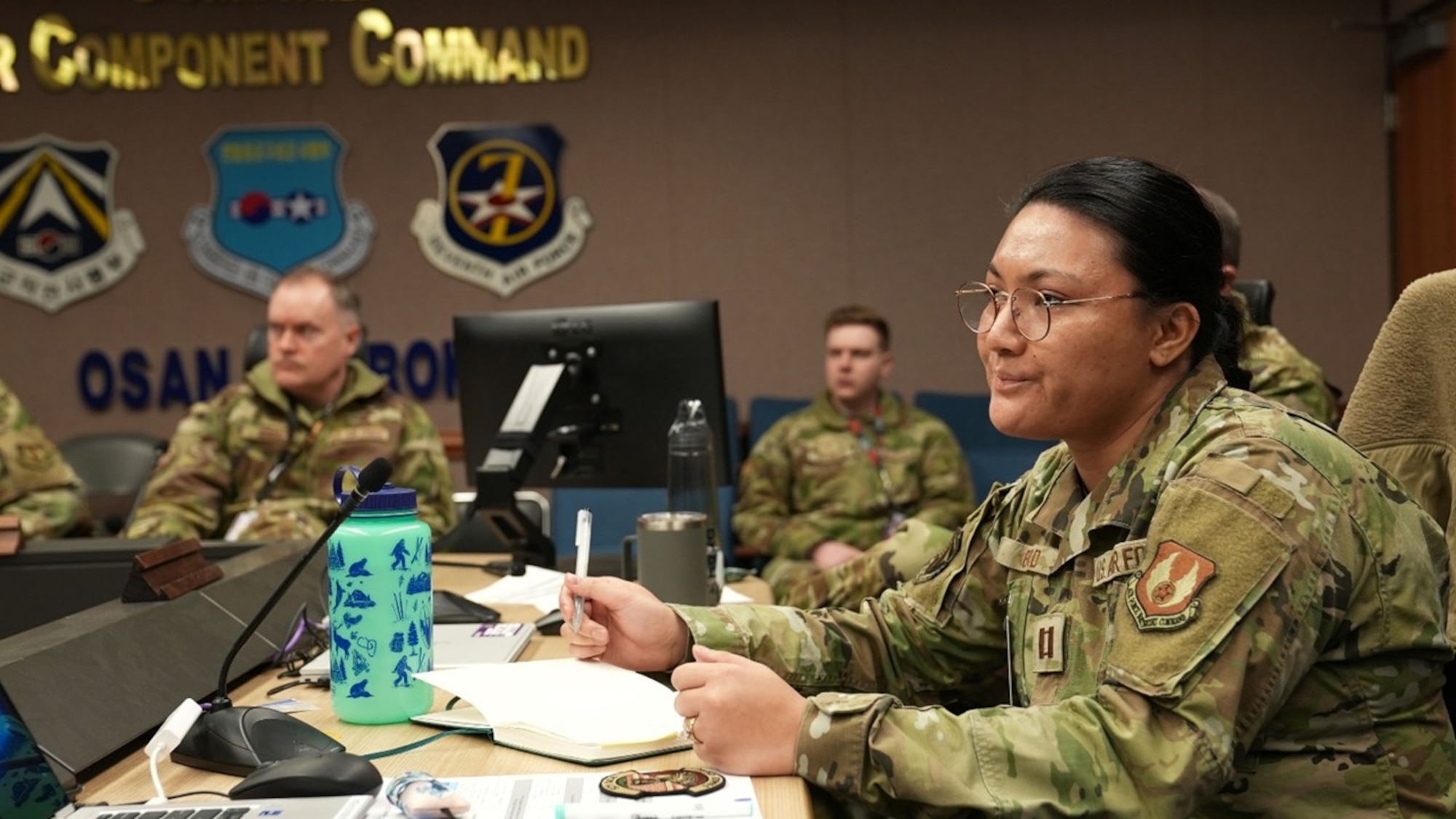 U.S. Air Force Capt. Tricia Byrd, Air Force Research Laboratory executive officer, takes notes during a collaboration session between the 607th Air Operations Center and AFRL personnel at Osan AFB, Republic of Korea, Jan. 19, 2026. As part of an initiative to partner more closely with warfighters, the AFRL team was immersed in the Pacific theater's integrated planning, execution and intelligence cycles to better align laboratory research and development with operational realities. (U.S. Air Force photo by Allegra Czerwinski)