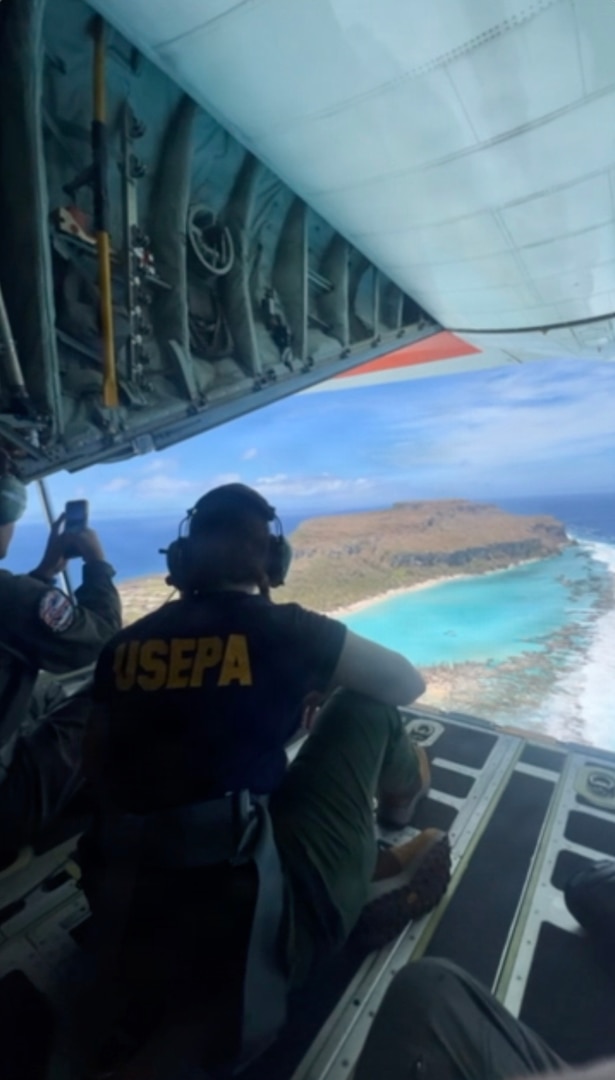 A U.S. Coast Guard HC-130J Hercules aircrew from Air Station Barbers Point conducts an overflight with a representative from the EPA and transports equipment to Rota in the Northern Mariana Islands on July 10, 2026. U.S. Coast Guard crews continue to assess and rectify discrepancies to aids to navigation, waterways, and channel conditions across the Marianas following Super Typhoon Bavi. (U.S. Coast Guard photo by Lt. j.g. Nomar Proctor)