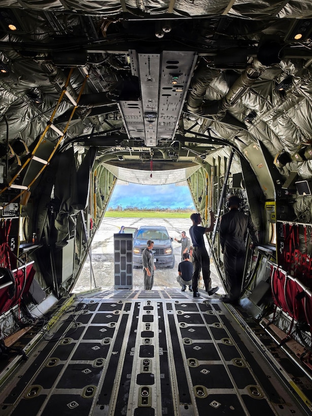 A U.S. Coast Guard HC-130J Hercules aircrew from Air Station Barbers Point conducts an overflight with a representative from the EPA and transports equipment to Rota in the Northern Mariana Islands on July 10, 2026. U.S. Coast Guard crews continue to assess and rectify discrepancies to aids to navigation, waterways, and channel conditions across the Marianas following Super Typhoon Bavi. (U.S. Coast Guard photo by Lt. j.g. Nomar Proctor)