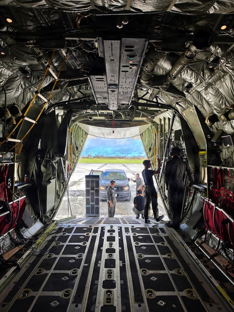 A U.S. Coast Guard HC-130J Hercules aircrew from Air Station Barbers Point conducts an overflight with a representative from the EPA and transports equipment to Rota in the Northern Mariana Islands on July 10, 2026. U.S. Coast Guard crews continue to assess and rectify discrepancies to aids to navigation, waterways, and channel conditions across the Marianas following Super Typhoon Bavi. (U.S. Coast Guard photo by Lt. j.g. Nomar Proctor)