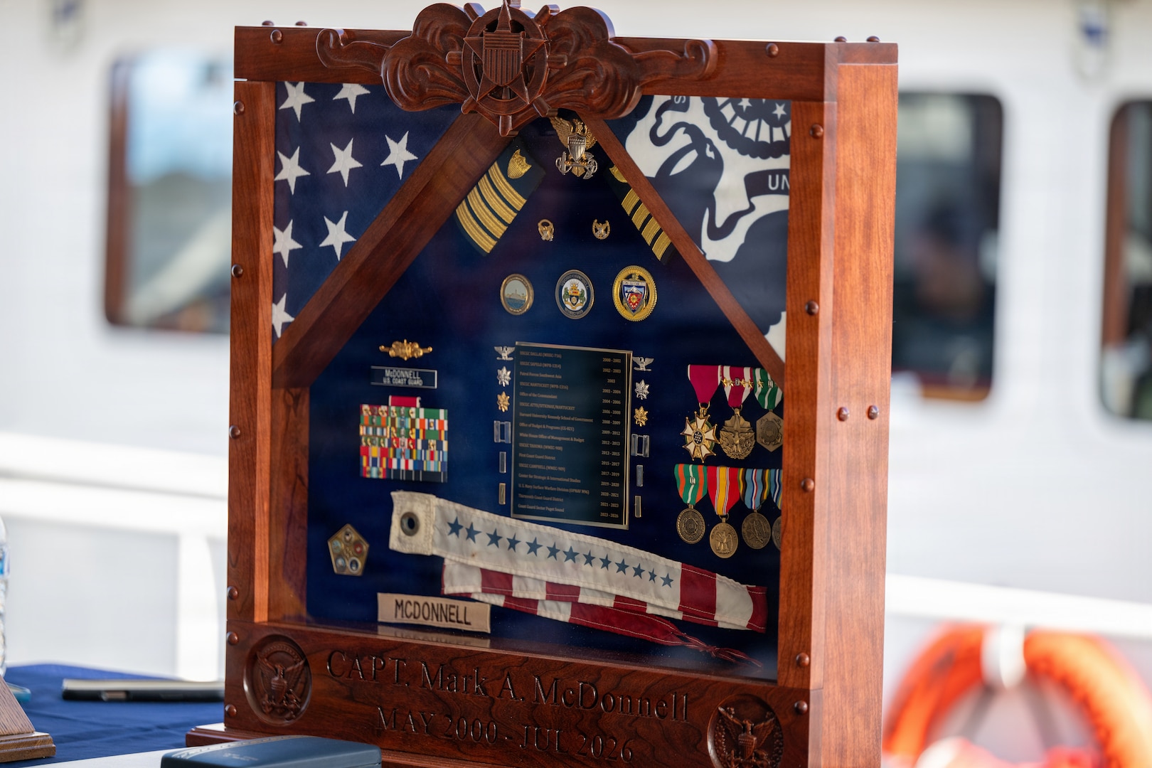 A shadowbox sits on display during the Coast Guard Sector Puget Sound change-of-command ceremony in Seattle, Washington, July 10, 2026