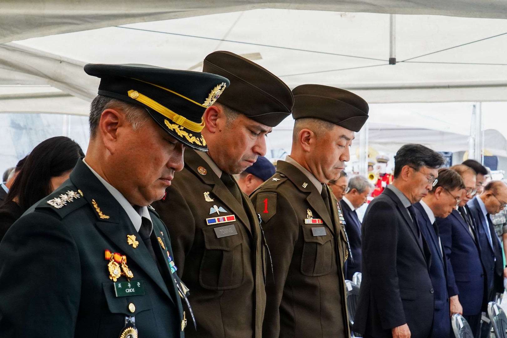 Members of the 19th Expeditionary Sustainment Command team bow their heads in respect during a commemoration ceremony for ROK Army Gen. Paik Sun Yup at the Dabu-dong War Memorial Museum in South Korea.