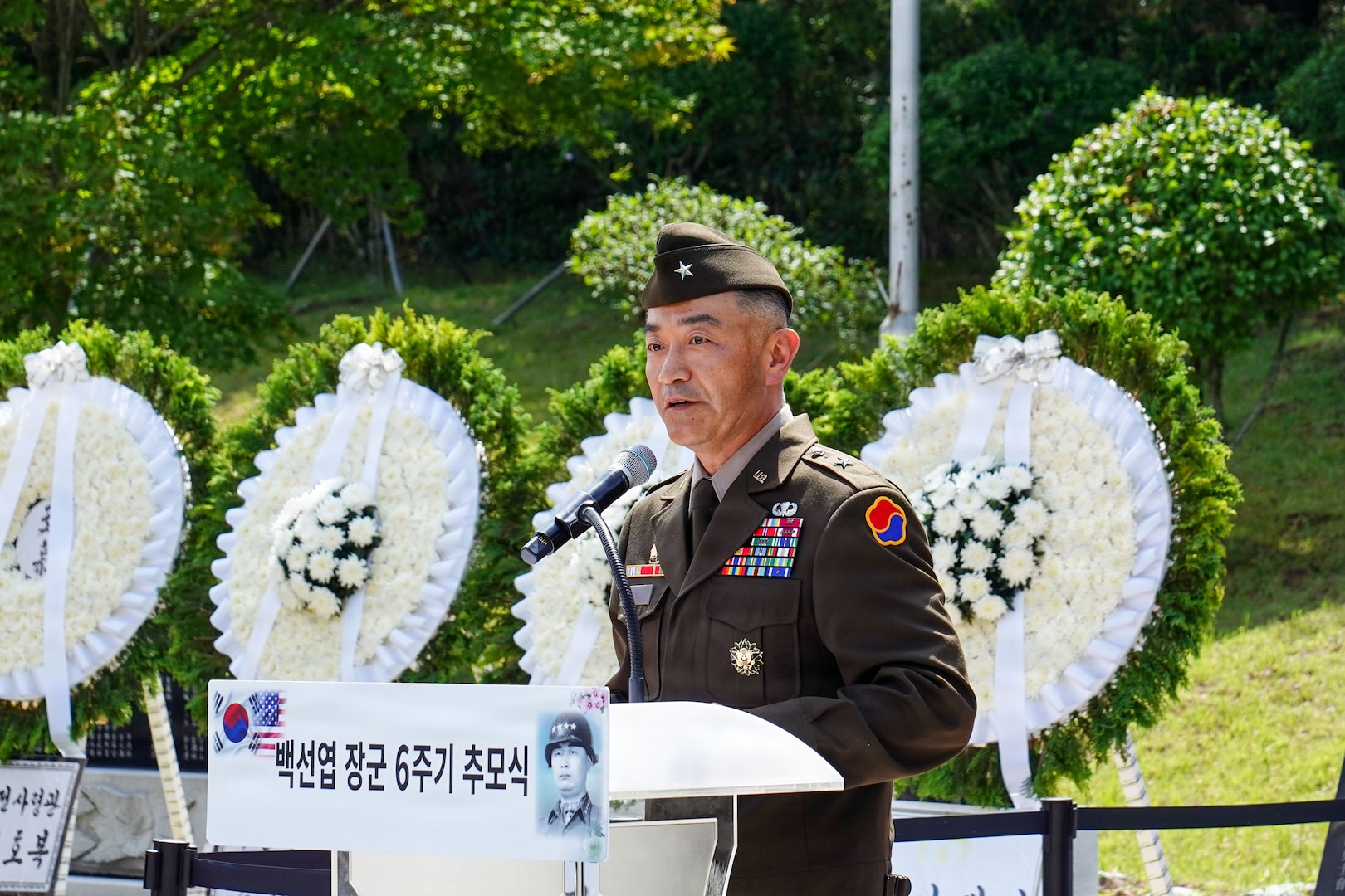 U.S. Army Brig. Gen. Jin Pak speaks at a podium during the sixth-anniversary commemoration ceremony for ROK Army Gen. Paik Sun Yup at the Dabu-dong War Memorial Museum in South Korea.