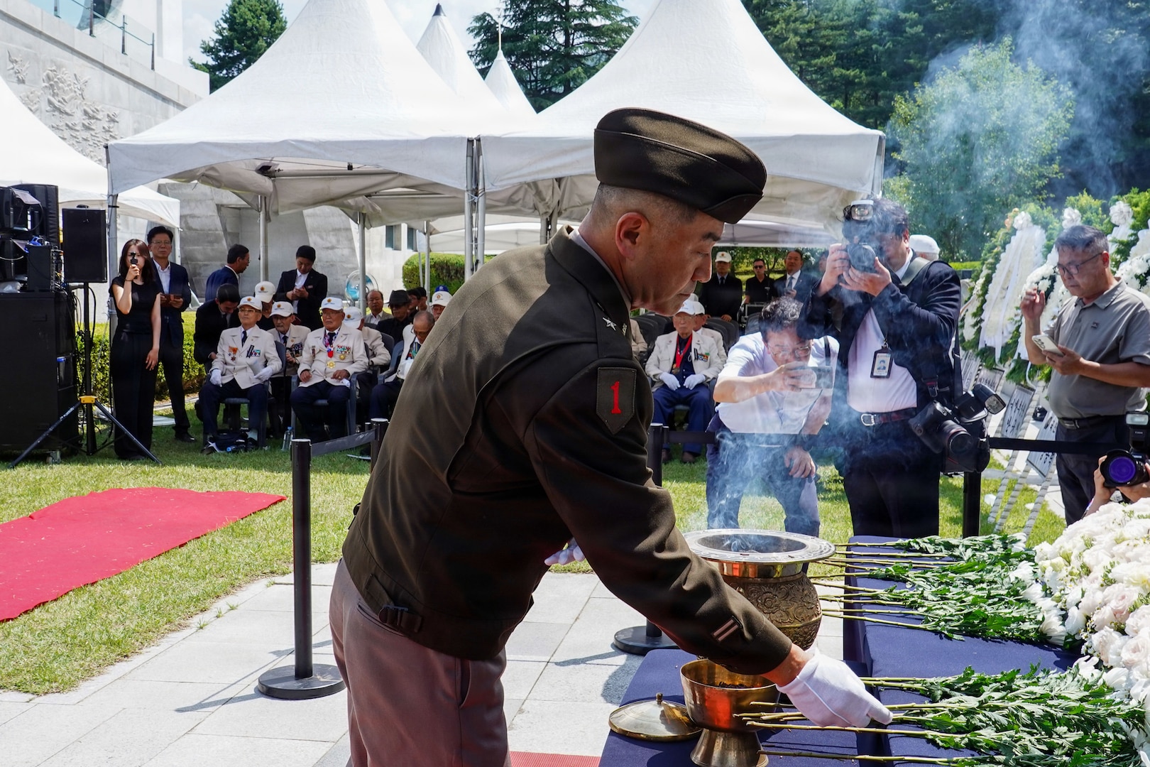 U.S. Army Brig. Gen. Jin Pak places a white flower on a memorial altar at the Dabu-dong War Memorial Museum in South Korea during a commemoration ceremony honoring the late ROK Army Gen. Paik Sun Yup.