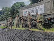U.S. Marines with 9th Engineer Support Battalion, Combat Logistics Regiment 35, 3rd Marine Logistics Group, transport intake hoses alongside Japan Ground Self-Defense Force personnel during exercise Resolute Dragon at JGSDF Camp Ishigaki, Okinawa, Japan, June 26, 2026. Resolute Dragon 26 is an annual bilateral exercise in Japan that strengthens the command, control, and multi-domain maneuver capabilities of U.S. Marines in III Marine Expeditionary Force and Japan Self-Defense Force personnel, with a focus on controlling and defending key maritime terrain. (U.S. Marine Corps photo by Cpl. Meshaq Hylton)