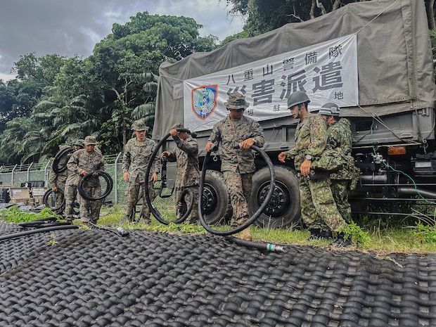 U.S. Marines with 9th Engineer Support Battalion, Combat Logistics Regiment 35, 3rd Marine Logistics Group, transport intake hoses alongside Japan Ground Self-Defense Force personnel during exercise Resolute Dragon at JGSDF Camp Ishigaki, Okinawa, Japan, June 26, 2026. Resolute Dragon 26 is an annual bilateral exercise in Japan that strengthens the command, control, and multi-domain maneuver capabilities of U.S. Marines in III Marine Expeditionary Force and Japan Self-Defense Force personnel, with a focus on controlling and defending key maritime terrain. (U.S. Marine Corps photo by Cpl. Meshaq Hylton)