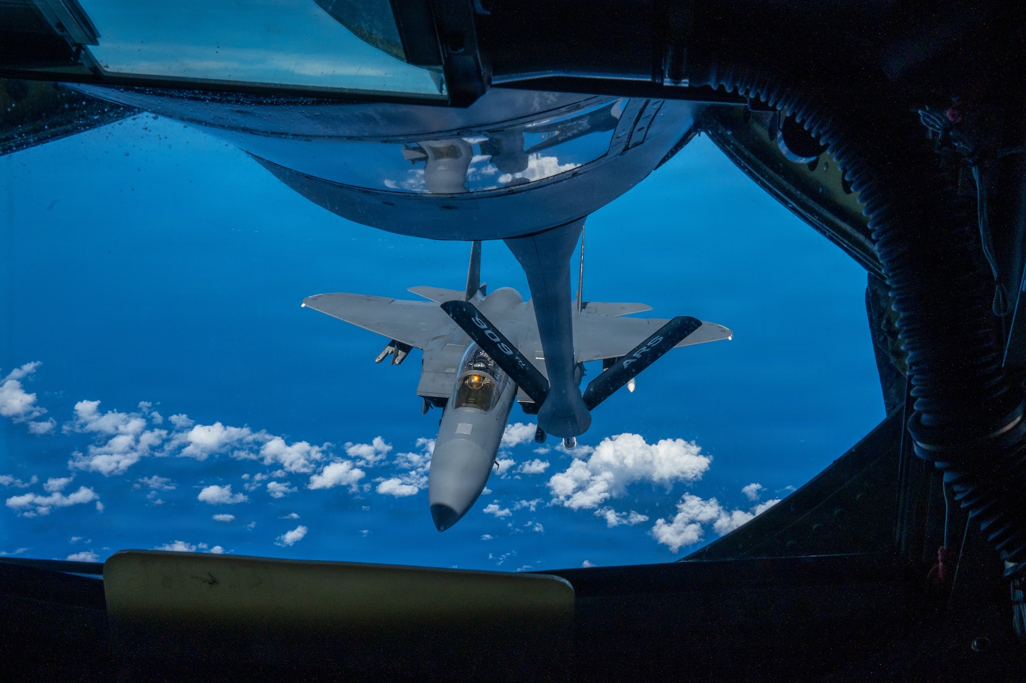 view of a fighter aircraft outside of a refueling aircrafts window
