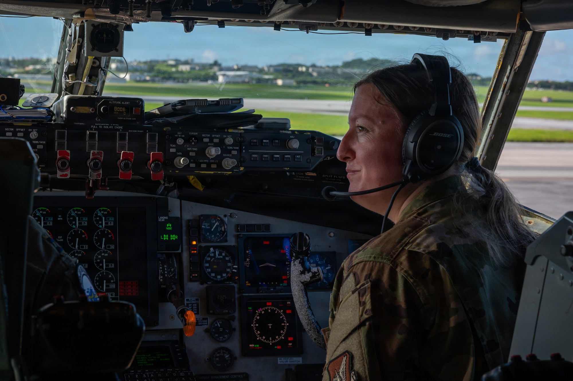a military service member sits in the cockpit and looks left