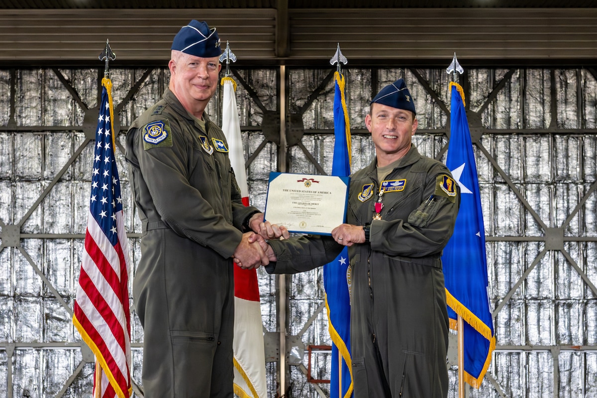 U.S. Air Force Lt. Gen. Joel Carey, left, 5th Air Force commander, presents an award to Col. Paul Davidson, outgoing 35th Fighter Wing (FW) commander, during a change of command ceremony.