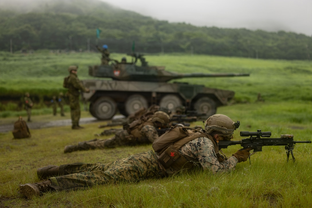 U.S. Marine Corps Lance Cpl. Dakota McGee, a rifleman with 12th Littoral Combat Team, 12th Marine Littoral Regiment, 3rd Marine Division, sights in his M27 infantry automatic rifle during a bilateral range during Resolute Dragon 26 at Japan Self-Defense Force Hijudai Maneuver Area, Oita Prefecture, Japan, June 28, 2026. Resolute Dragon 26 is an annual bilateral exercise in Japan that strengthens the command, control, and multi-domain maneuver capabilities of U.S. Marines in III Marine Expeditionary Forces and Japan Self-Defense Forces personnel, with a focus on controlling and defending key maritime terrain. McGee is a native of Mississippi. (U.S. Marine Corps photo by Lance Cpl. Camila Garibay)