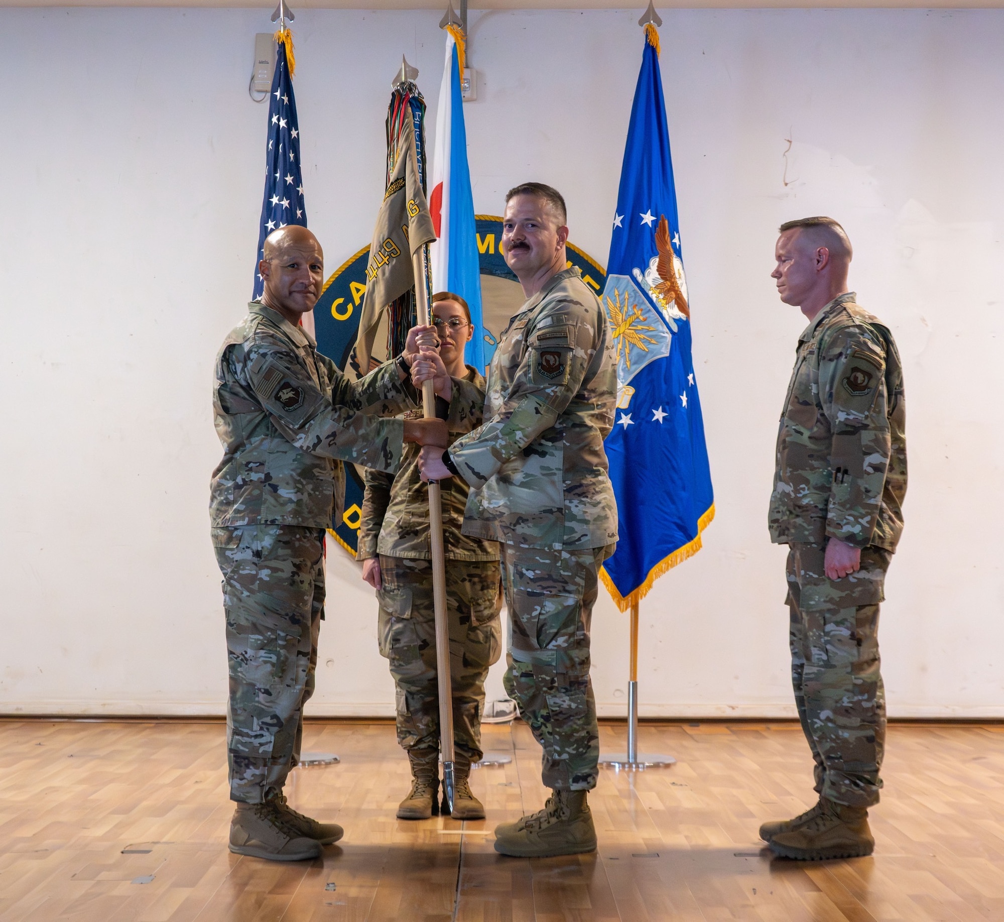U.S. Air Force Chief Master Sgt. Christopher Turknett, 449th Air Expeditionary Group senior enlisted leader, center, accepts responsibility of the 449th AEG senior enlisted position during a Change of Responsibility ceremony at Camp Lemonnier, Djibouti, June 18, 2026. The Change of Responsibility ceremony represents a formal transfer of responsibility from one senior enlisted leader to another, reinforcing their authority in the Air Force and support to the chain of command. (U.S. Air Force photo by Senior Airman Luis Gomez)