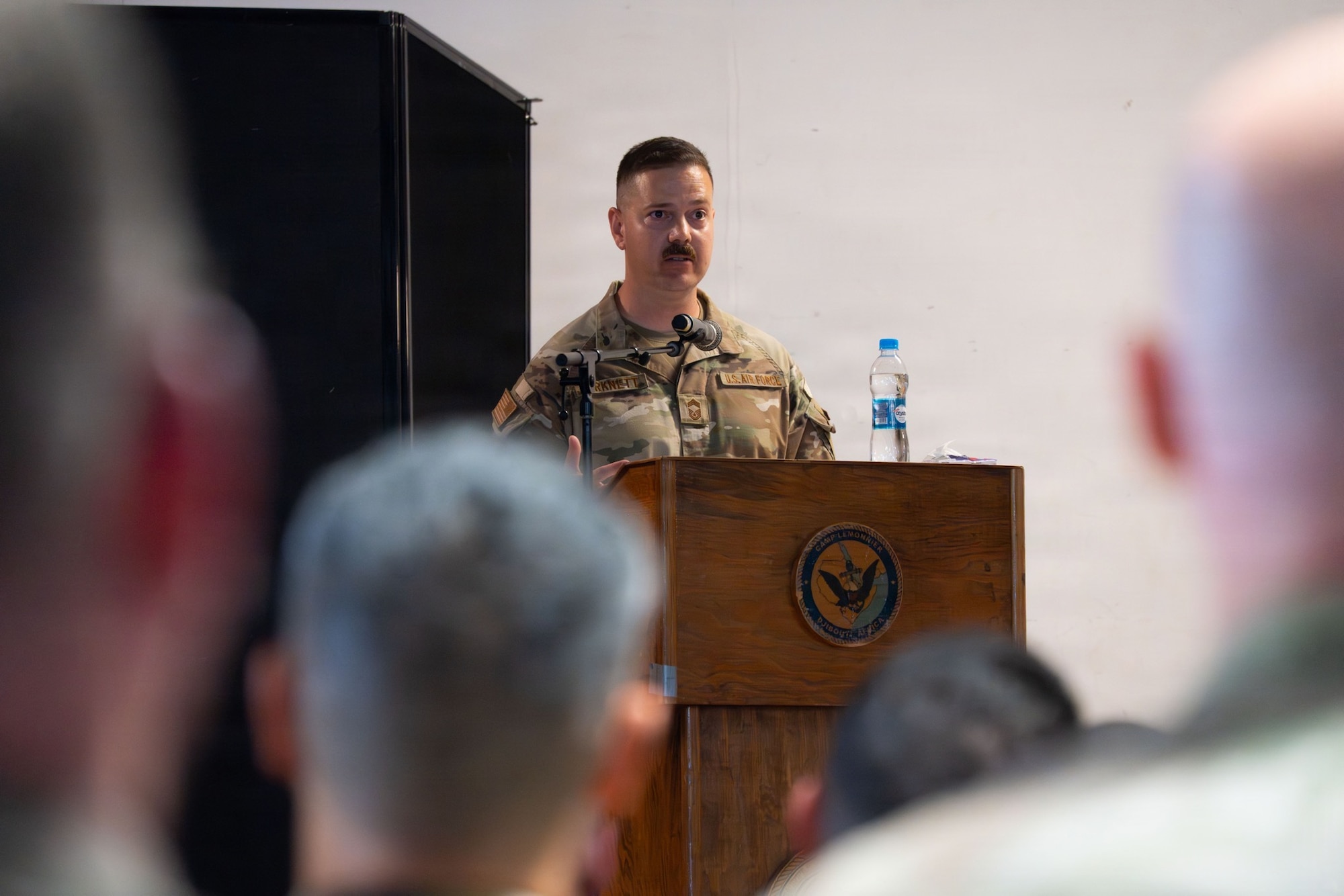 U.S. Air Force Chief Master Sgt. Christopher Turknett, 449th Air Expeditionary Group senior enlisted leader, gives his first remarks after the 449th AEG Change of Responsibility ceremony at Camp Lemonnier, Djibouti, June 18, 2026. The 449th AEG provides personnel recovery task forces, intra-theater airlift, base operating support integrator, intelligence, surveillance, and reconnaissance capabilities, and aircraft launch and recovery elements in support of U.S. Central Command and U.S. Africa Command mission requirements, including support to regional partners. (U.S. Air Force photo by Senior Airman Luis Gomez)