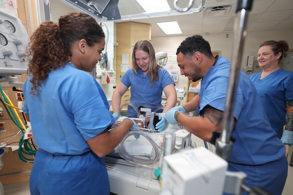A team of respiratory therapists and a nurse at U.S. Naval Hospital Guam practice setting up bubble continuous positive airway pressure (CPAP) on a simulated infant patient in the hospital’s nursery. Bubble CPAP is a gentle way to help newborns, particularly premature babies, who are having trouble breathing. USNH Guam is expanding pediatric capabilities to improve care, increase local medical capacity, and strengthen operational readiness across the Indo-Pacific. By increasing treatment capability on island, USNH Guam ensures service members and their families receive the care they need, where they serve.
