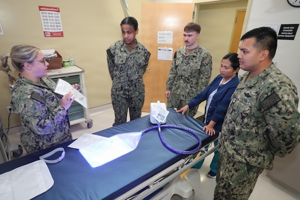 A team of hospital corpsmen who work in the Pediatrics Department at U.S. Naval Hospital Guam train on the use of a "Bili Blanket."  This device is part of a new phototherapy program offered by the hospital that allows babies diagnosed with jaundice, a common condition that causes yellowing of the skin, to receive blue-wavelength light therapy in a monitored home setting. Previously, babies who needed this treatment had to stay in the hospital. Now, they can be safely cared for as outpatients, reducing the need for hospital admission and repeated laboratory testing, while keeping families together during their newborn’s crucial first weeks of life. Devices will be issues to TRICARE-eligible beneficiaries for short-term use, while pediatric providers closely monitor the infant’s progress. This program is part of USNH Guam's efforts to expand pediatric capabilities to increase local medical capacity and ensure service members and their families receive the care they need, where they serve.