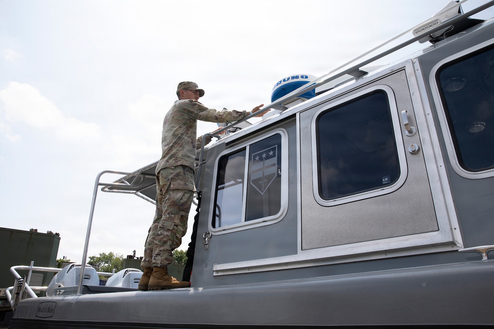 U.S. Army National Guard Spc. Luke Martinez Acuna, assigned to Joint Task Force- District of Columbia in support of the DC Safe and Beautiful mission, conducts Preventive Maintenance Checks and Services on a boat to ensure its mission capability on Joint Base Anacostia-Bolling in Washington, D.C., July 8, 2026.