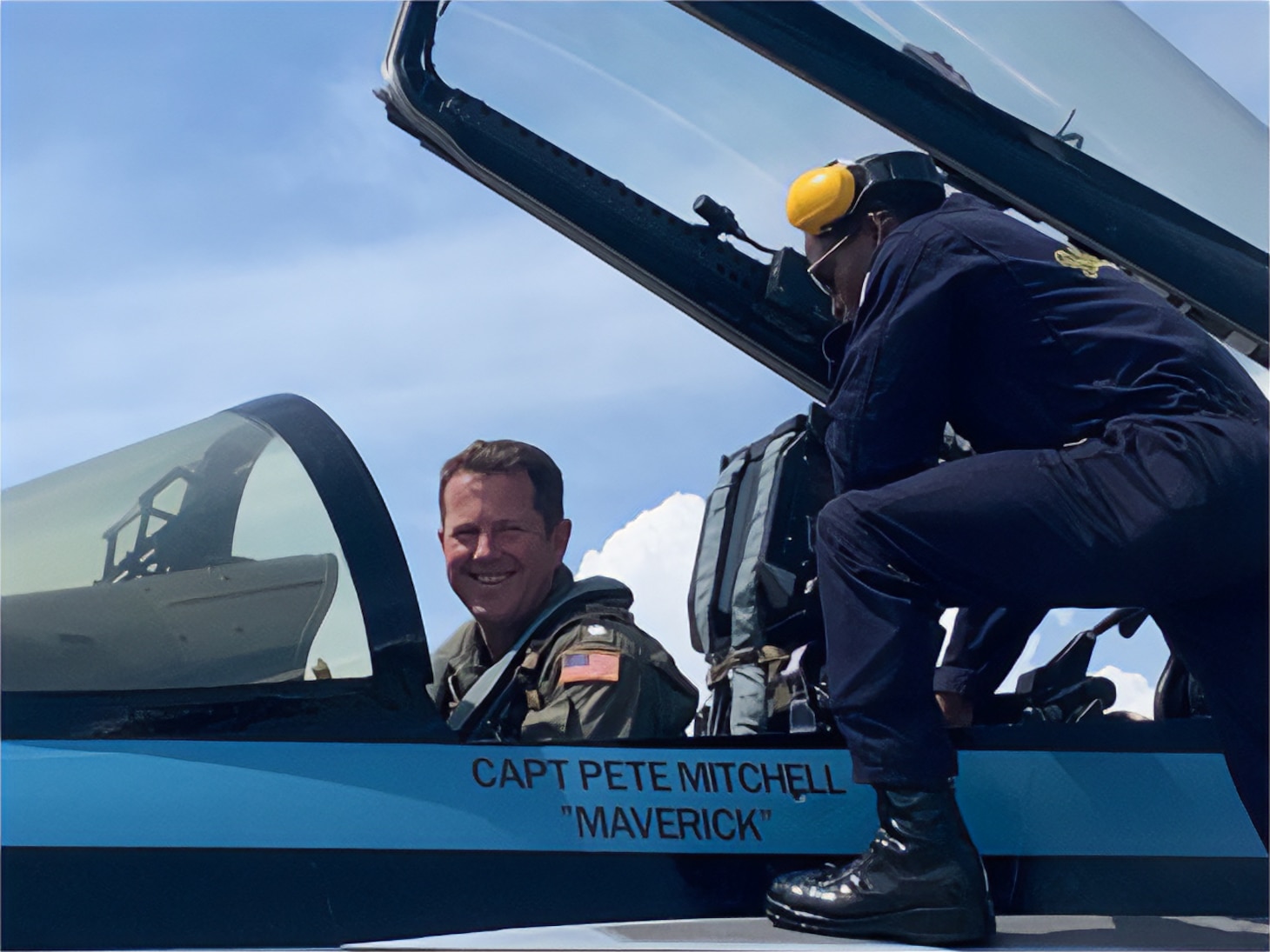 Crew chief Aviation Ordnanceman 2nd Class Aldriick Kittles helps Cmdr. Frank Weisser strap into his specially painted F/A-18E Super Hornet during filming for the second “Top Gun” movie.