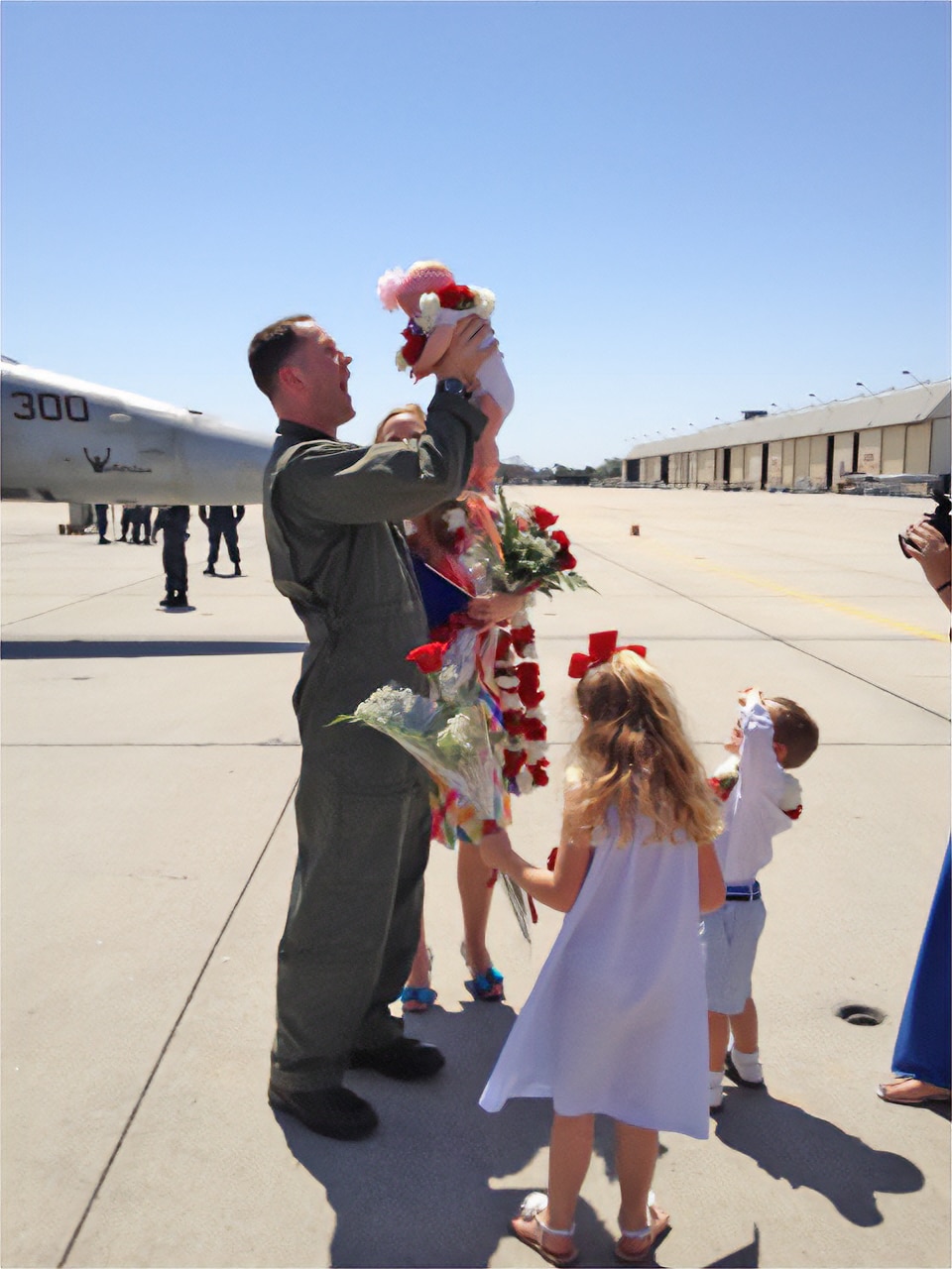 In an end-of-cruise scene familiar to anyone who has returned from a long deployment, Cmdr. Frank Weisser holds his newborn daughter for the first time on April 28, 2013.