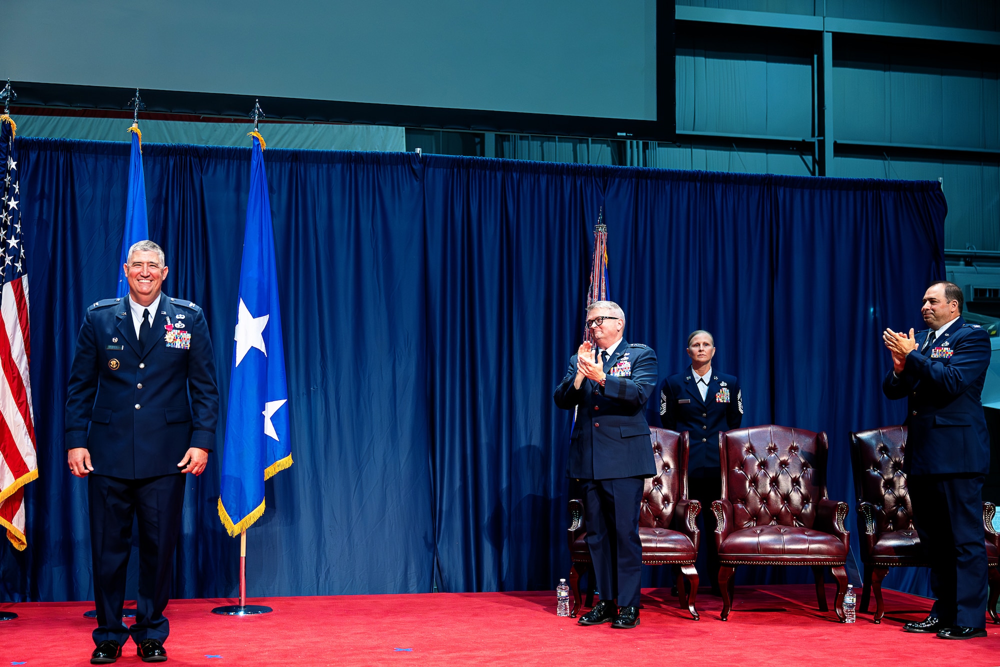 Col. Kenneth Stremmel, outgoing National Air and Space Intelligence Center commander, receives a standing ovation after receiving the Legion of Merit during a change of command ceremony at the National Museum of the United States Air Force, Wright-Patterson Air Force Base, Ohio, July 10, 2026. Stremmel, who was recently selected for promotion to brigadier general, departs NASIC to begin his next assignment at the Pentagon. (U.S. Air Force photo by Staff Sgt. Kristof J. Rixmann)