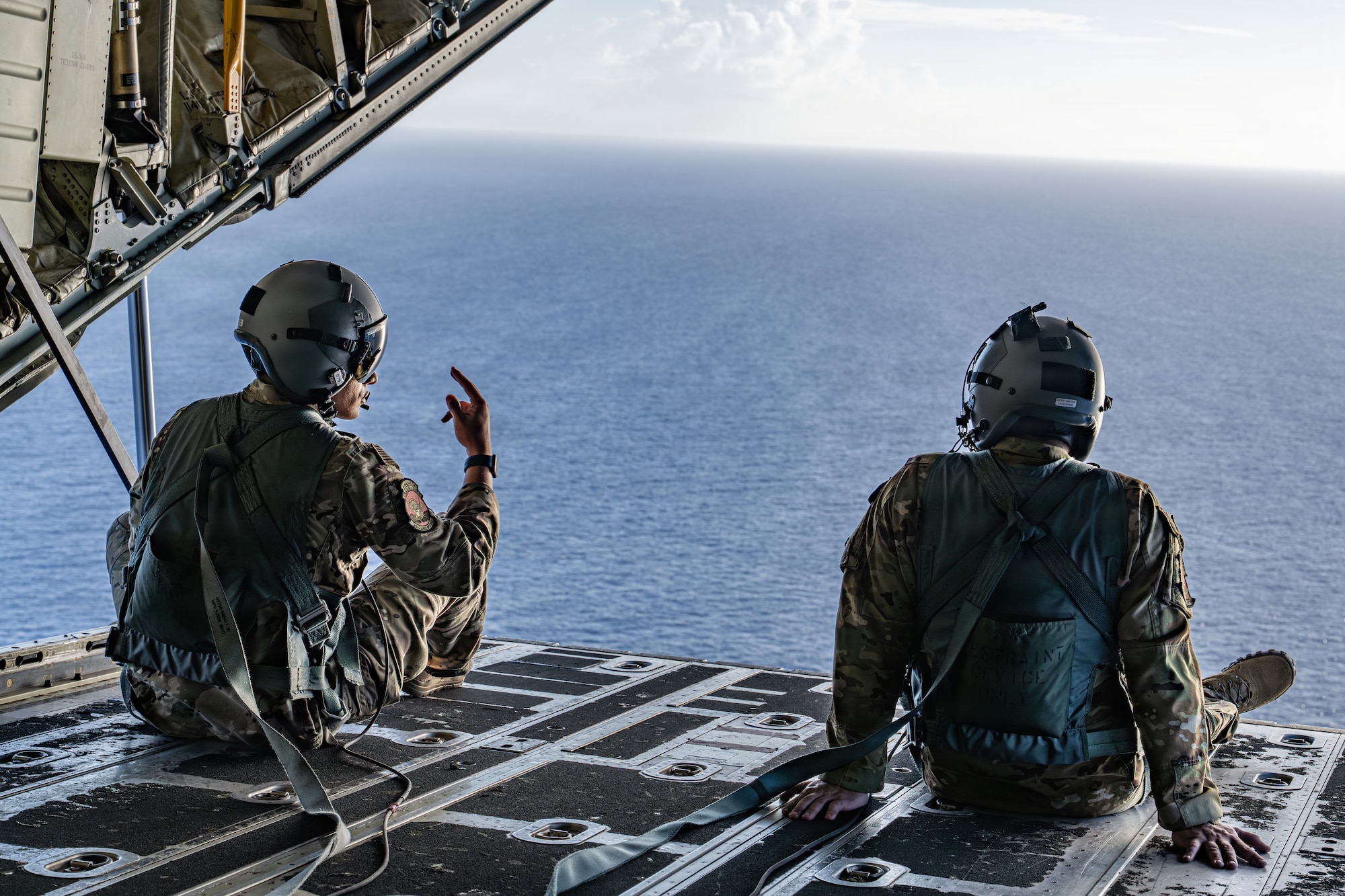 U.S. Air Force Staff Sgt. Darius Anthony, 39th Airlift Squadron advanced instructor loadmaster, and Airman 1st Class Samuel Hampton, 39th AS loadmaster, simulate sea rescue kit and Low Cost Low Altitude airdrops over the Philippine Sea, June 29, 2026, in support of VALIANT SHIELD 2026. Exercises like VALIANT SHIELD allow Pacific Command Joint Forces the opportunity to integrate forces from all branches of service and with our allies to conduct precise, lethal, and overwhelming multi-axis, multi-domain effects that demonstrate the strength and versatility of the joint force and our commitment to a free and open Indo-Pacific. (U.S. Air Force photo by Airman 1st Class Caleb Schellenberg)