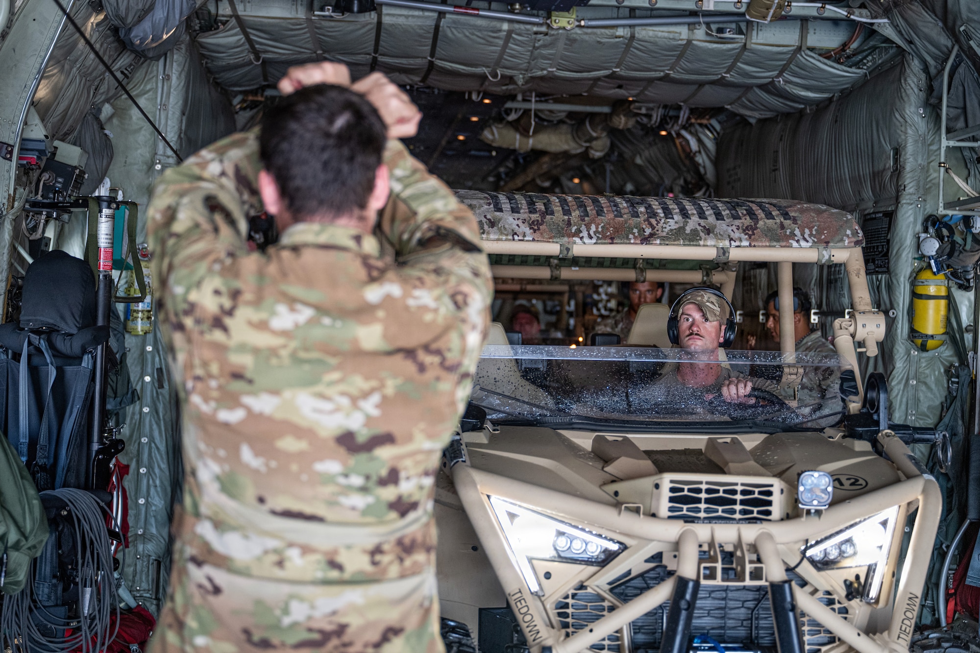 U.S. Air Force Airman 1st Class Samuel Hampton, 39th Airlift Squadron loadmaster, guides a Polaris MRZR onto a C-130J Super Hercules at Saipan International Airport, Northern Mariana Islands,  June 29, 2026, in support of VALIANT SHIELD 2026. Exercises like VALIANT SHIELD allow Pacific Command Joint Forces the opportunity to integrate forces from all branches of service and with our allies to conduct precise, lethal, and overwhelming multi-axis, multi-domain effects that demonstrate the strength and versatility of the joint force and our commitment to a free and open Indo-Pacific. (U.S. Air Force photo by Airman 1st Class Caleb Schellenberg)