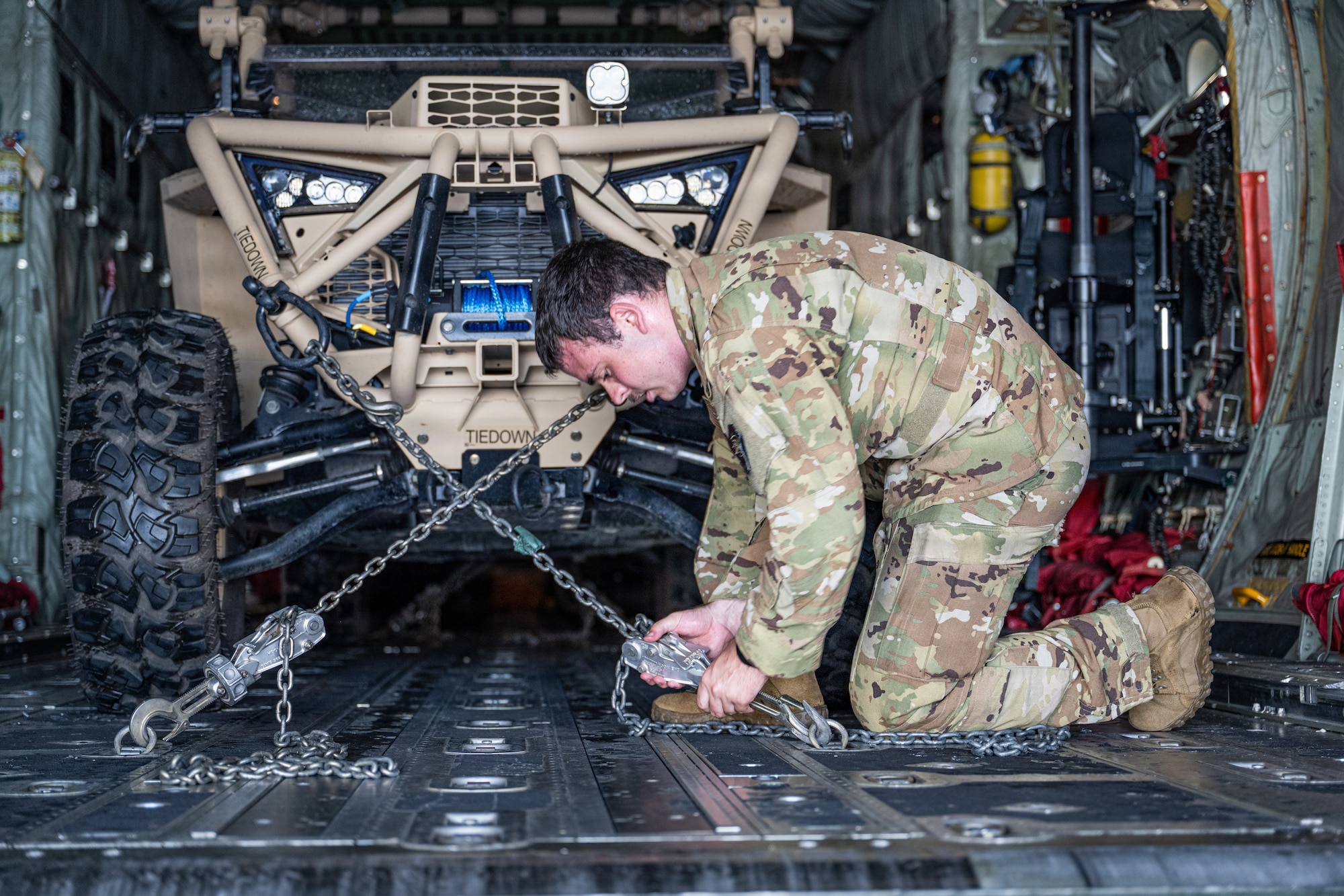 U.S. Air Force Airman 1st Class Samuel Hampton, 39th Airlift Squadron loadmaster, secures a Polaris MRZR onto a C-130J Super Hercules at Saipan International Airport, Northern Mariana Islands, June 29, 2026, in support of VALIANT SHIELD 2026. Exercises like VALIANT SHIELD allow Pacific Command Joint Forces the opportunity to integrate forces from all branches of service and with our allies to conduct precise, lethal, and overwhelming multi-axis, multi-domain effects that demonstrate the strength and versatility of the joint force and our commitment to a free and open Indo-Pacific. (U.S. Air Force photo by Airman 1st Class Caleb Schellenberg)