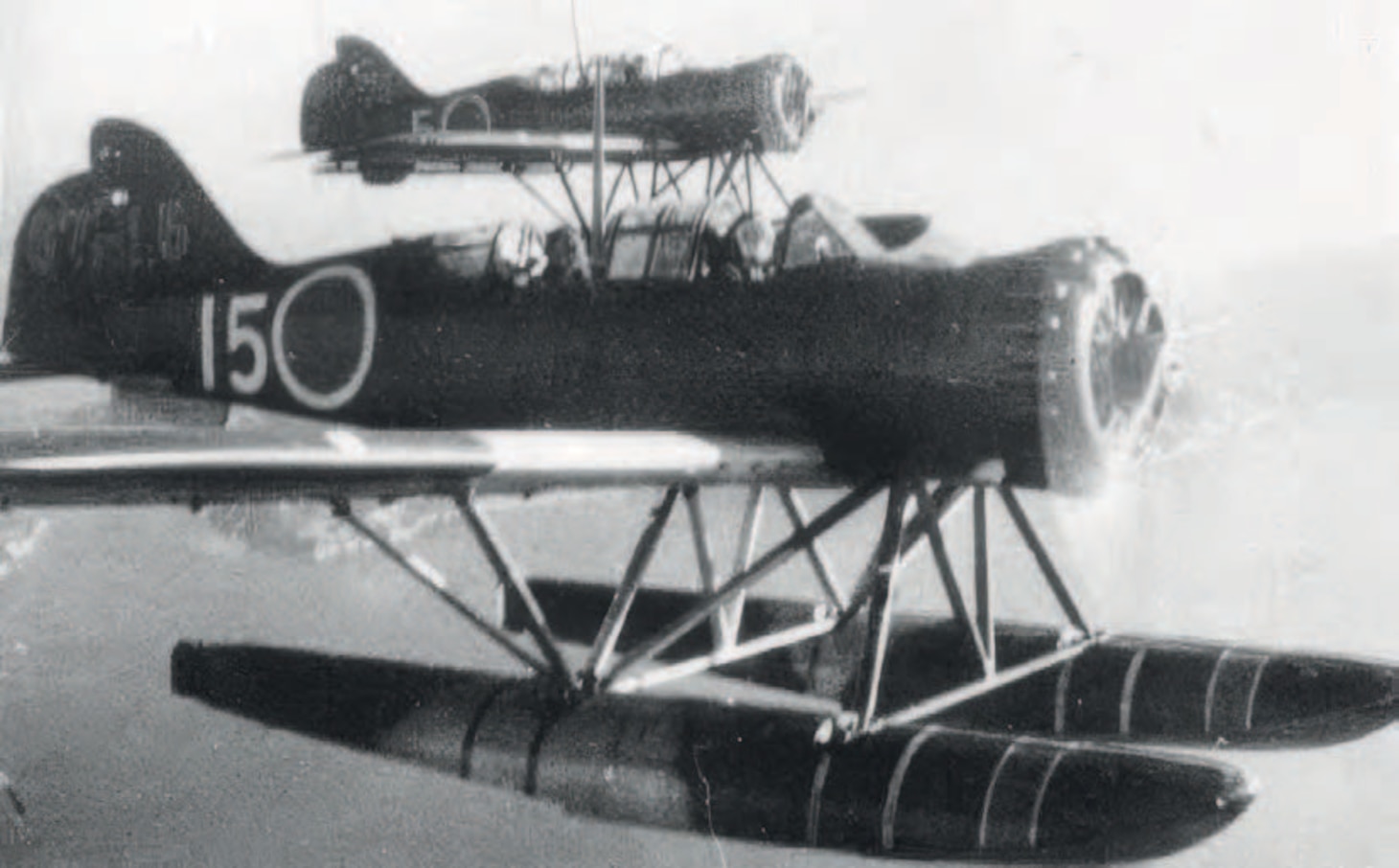 Two E14Y1 Model 11 floatplanes fly in formation over the Kure Naval Base.