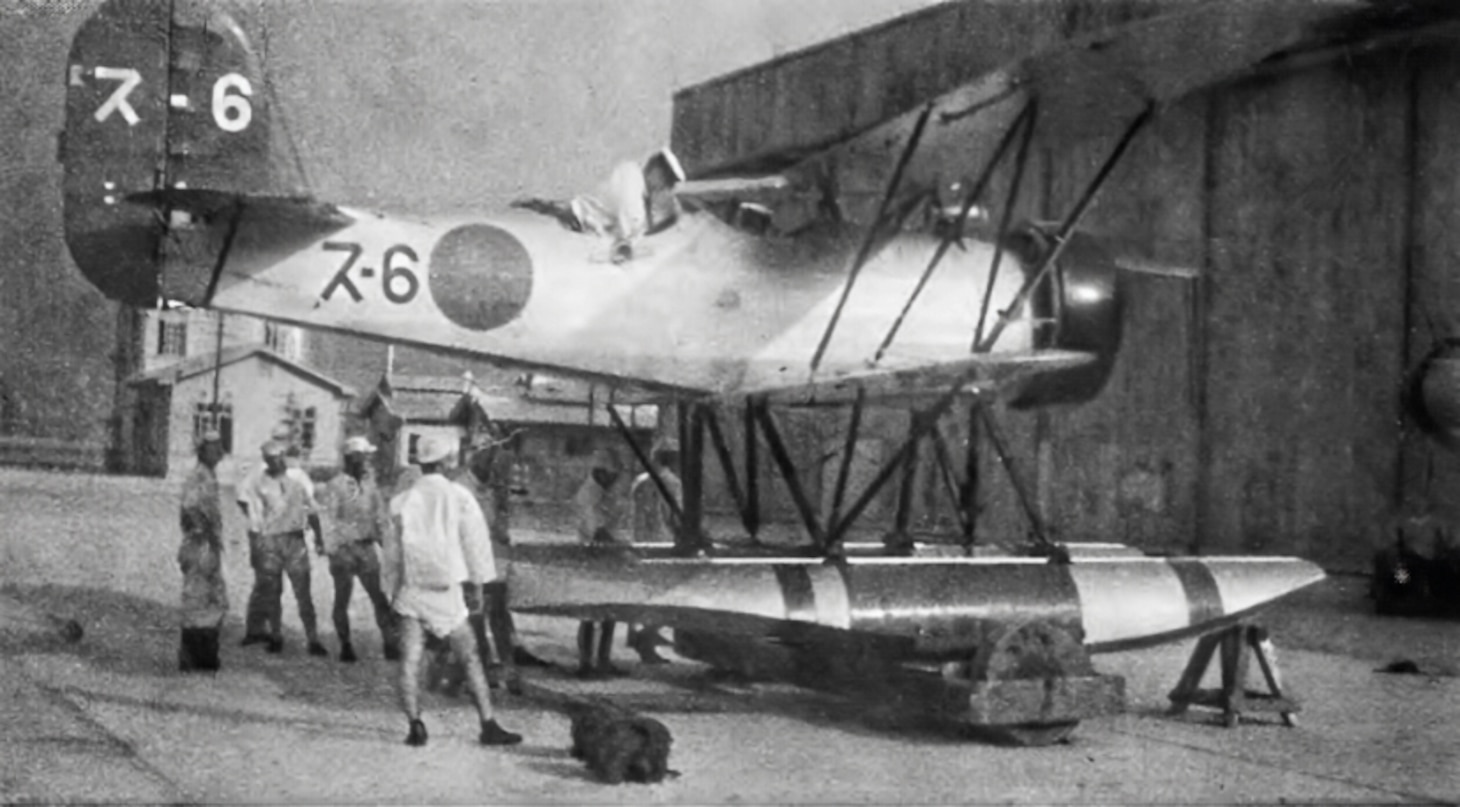 A production Watanabe E9W1 reconnaissance floatplane assigned to submarine I-6 undergoes a technical inspection at Kure in 1937. Note the Japanese character and Roman numeral on the vertical tail.