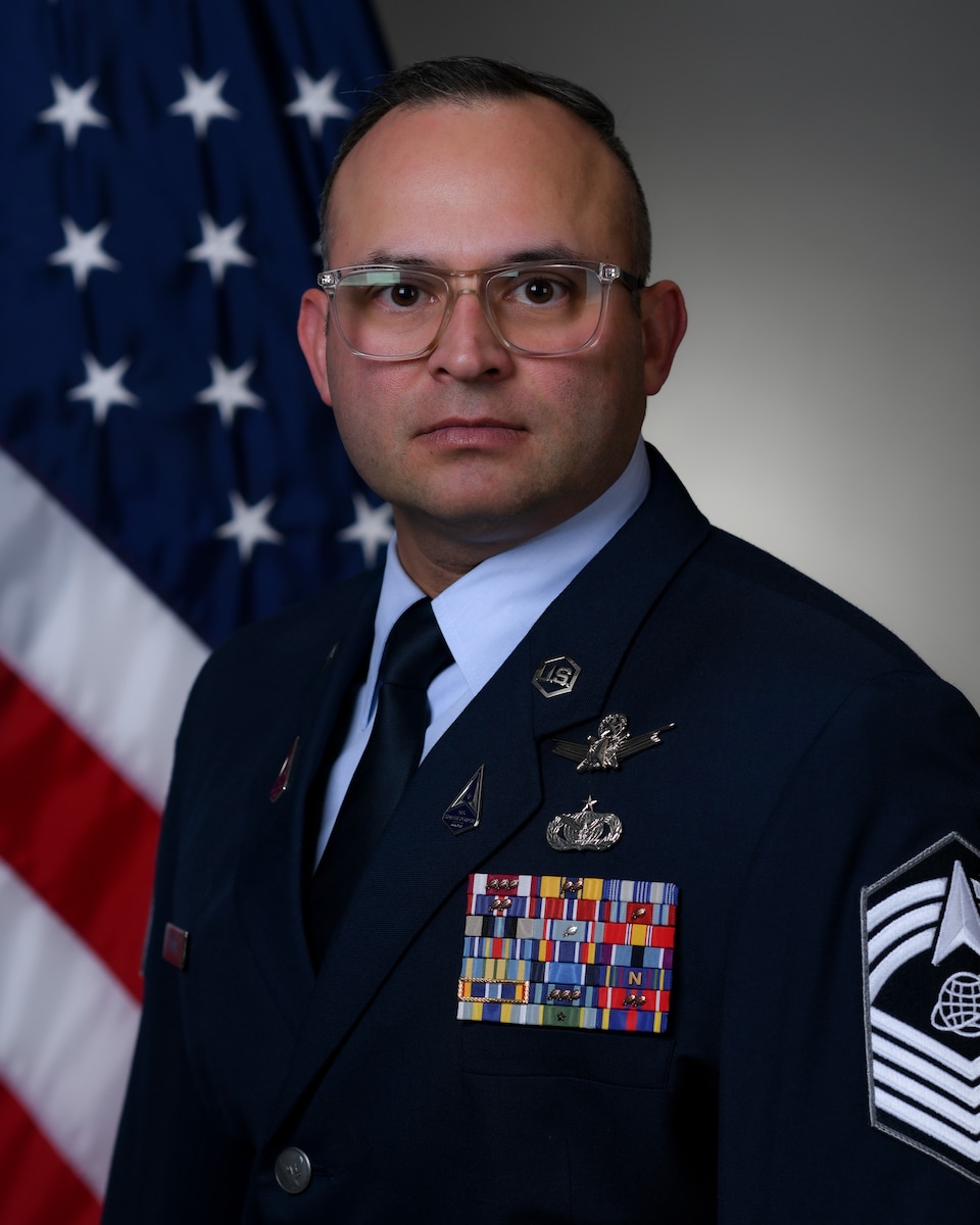 Man in uniform with flag in background