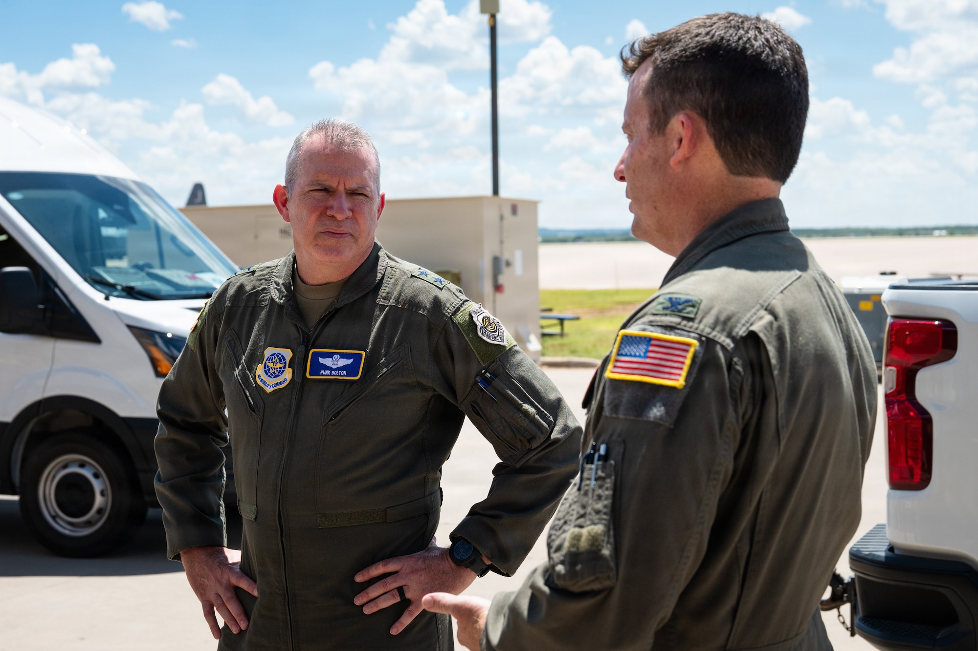 U.S. Air Force Maj. Gen. Charles Bolton, left, Eighteenth Air Force commander, discusses 317th Airlift Wing facilities with Col. Justin Diehl, 317th AW commander, prior to presenting the Gallant Unit Citation to the 40th Airlift Squadron at Dyess Air Force Base, Texas, July 7, 2026. Bolton recognized the wing’s achievements in recent months and discussed potential building plans that advance future operations. (U.S. Air Force photo by Senior Airman Jade M. Caldwell)