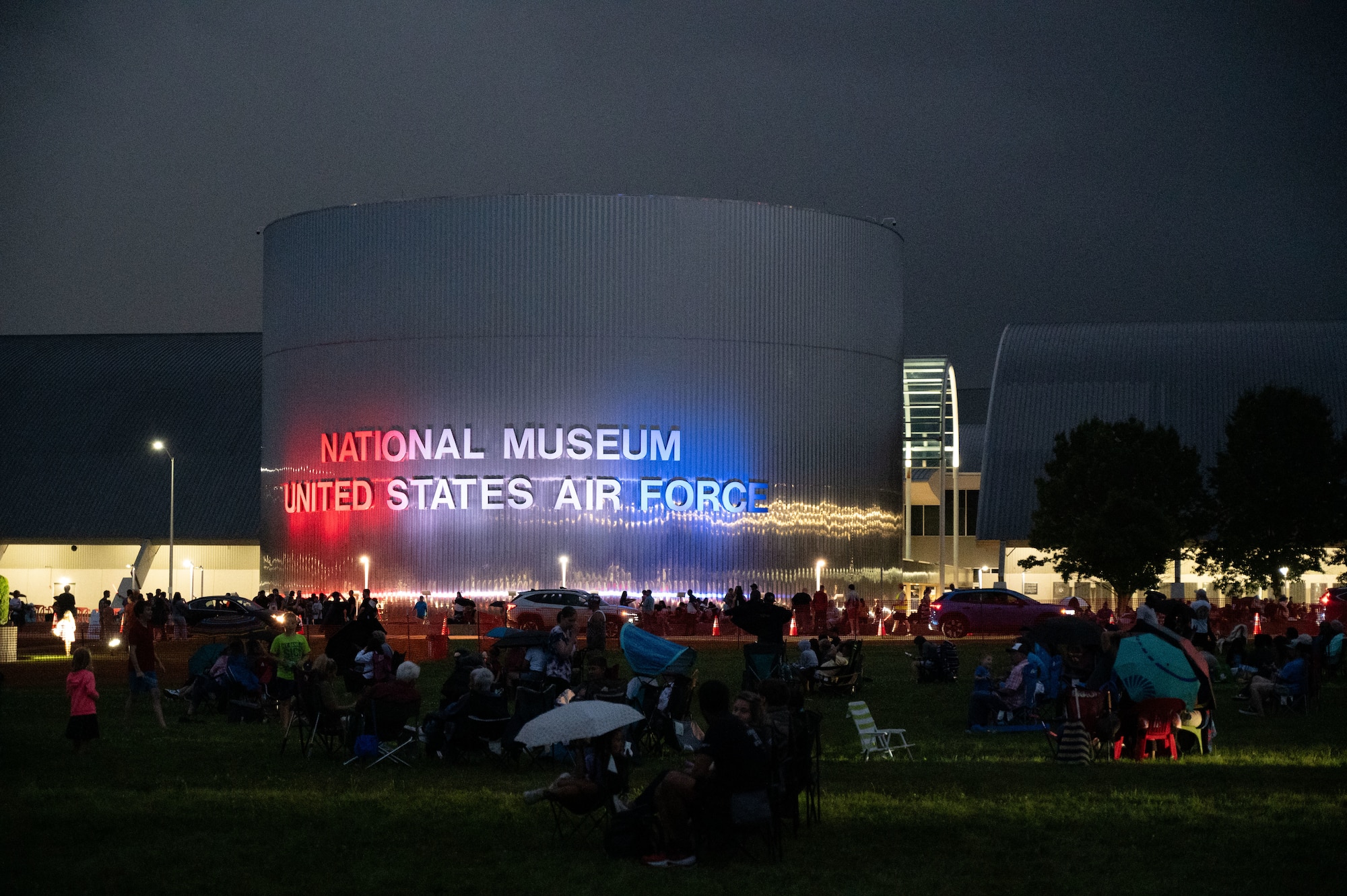crowds on the front lawn of the National Museum of the U.S. Air Force at dusk