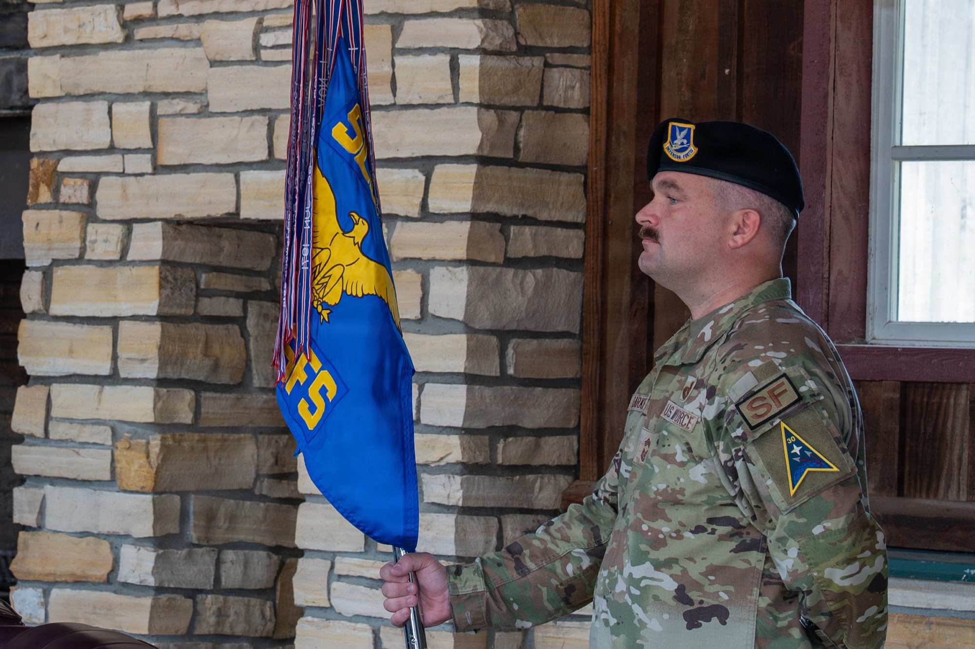 A person stands and holds a flag