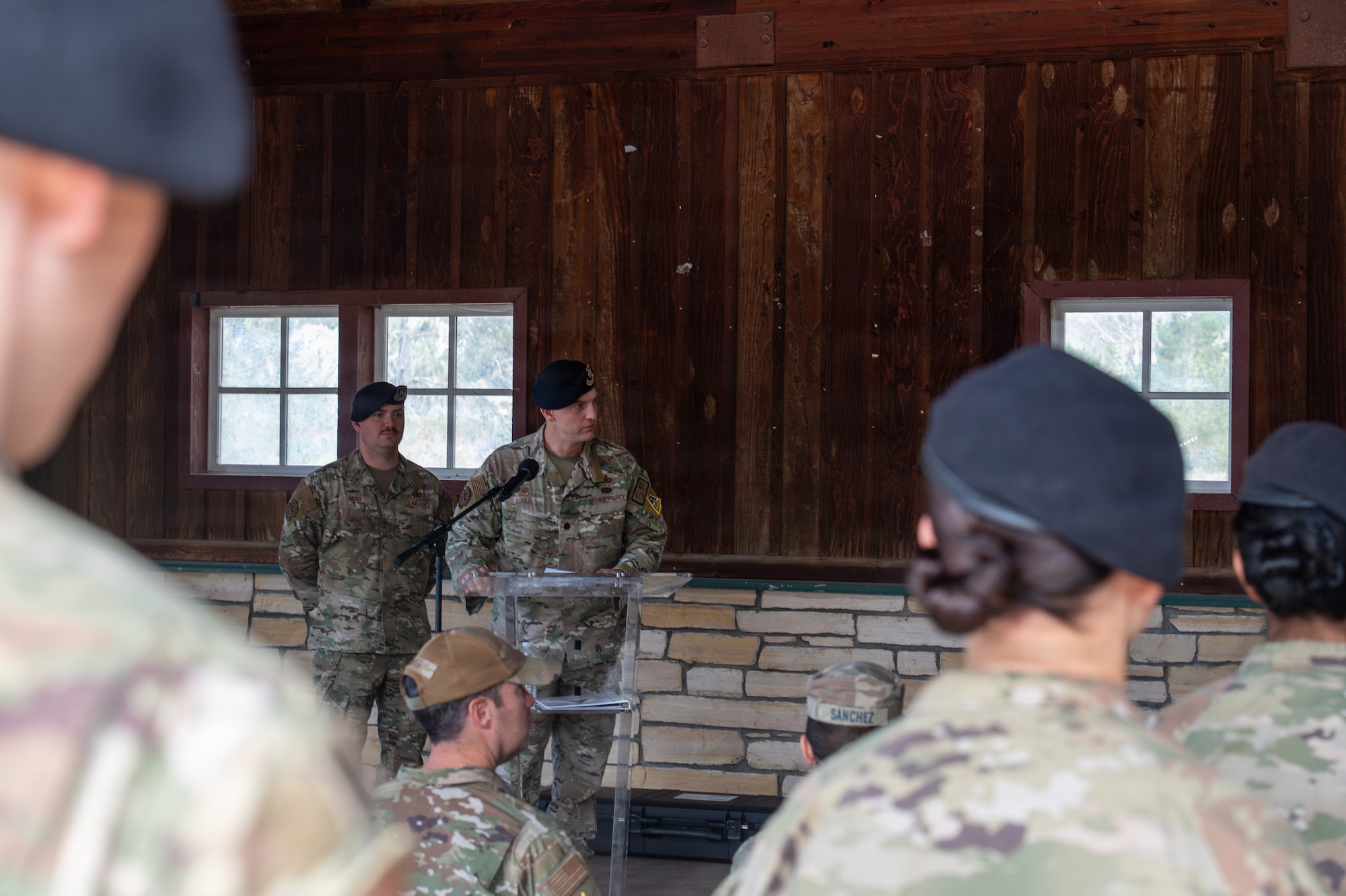 A person stands and speaks behind a podium