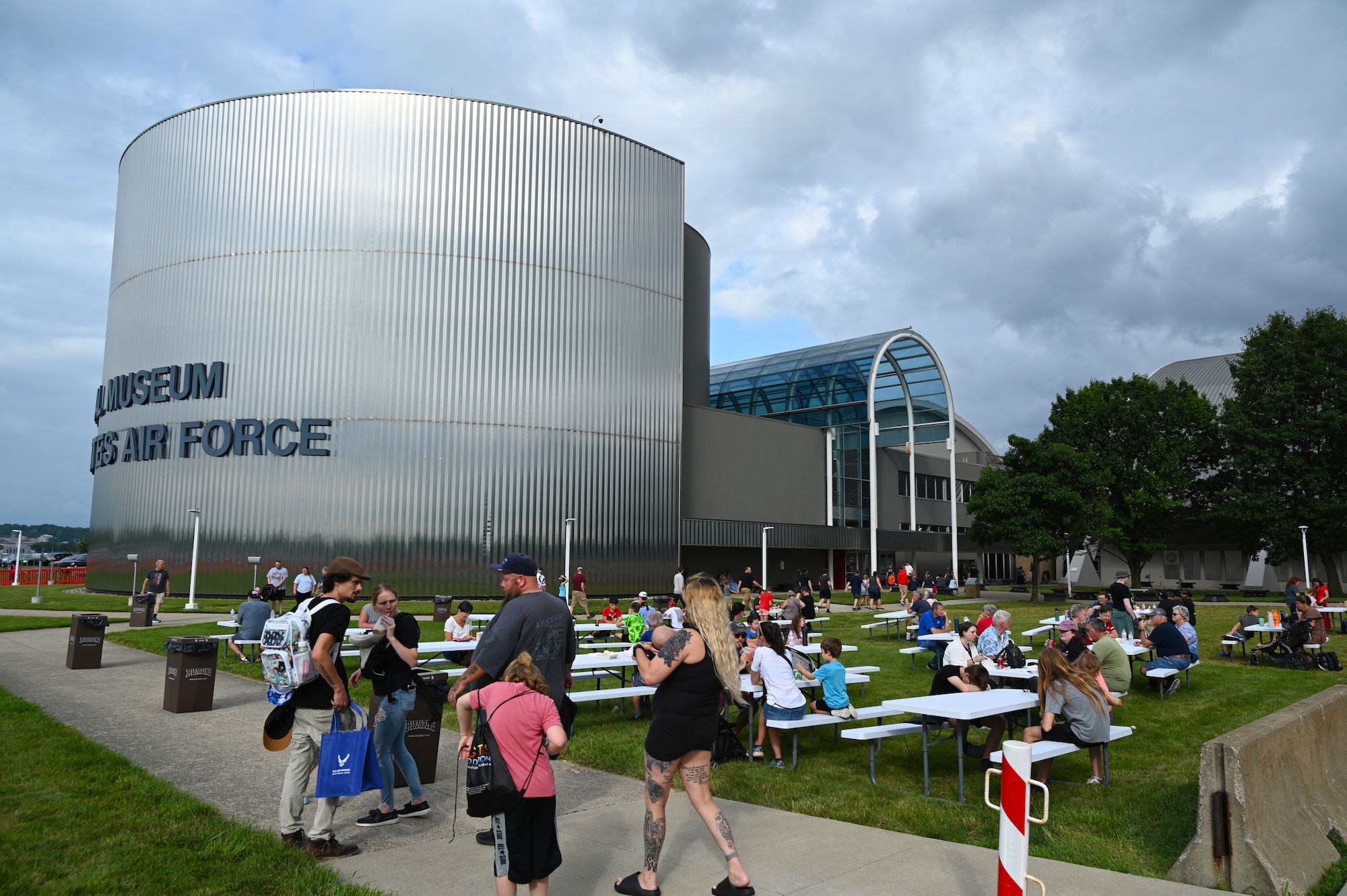 Guests enjoy food and company at the picnic tables set up in front the museum.