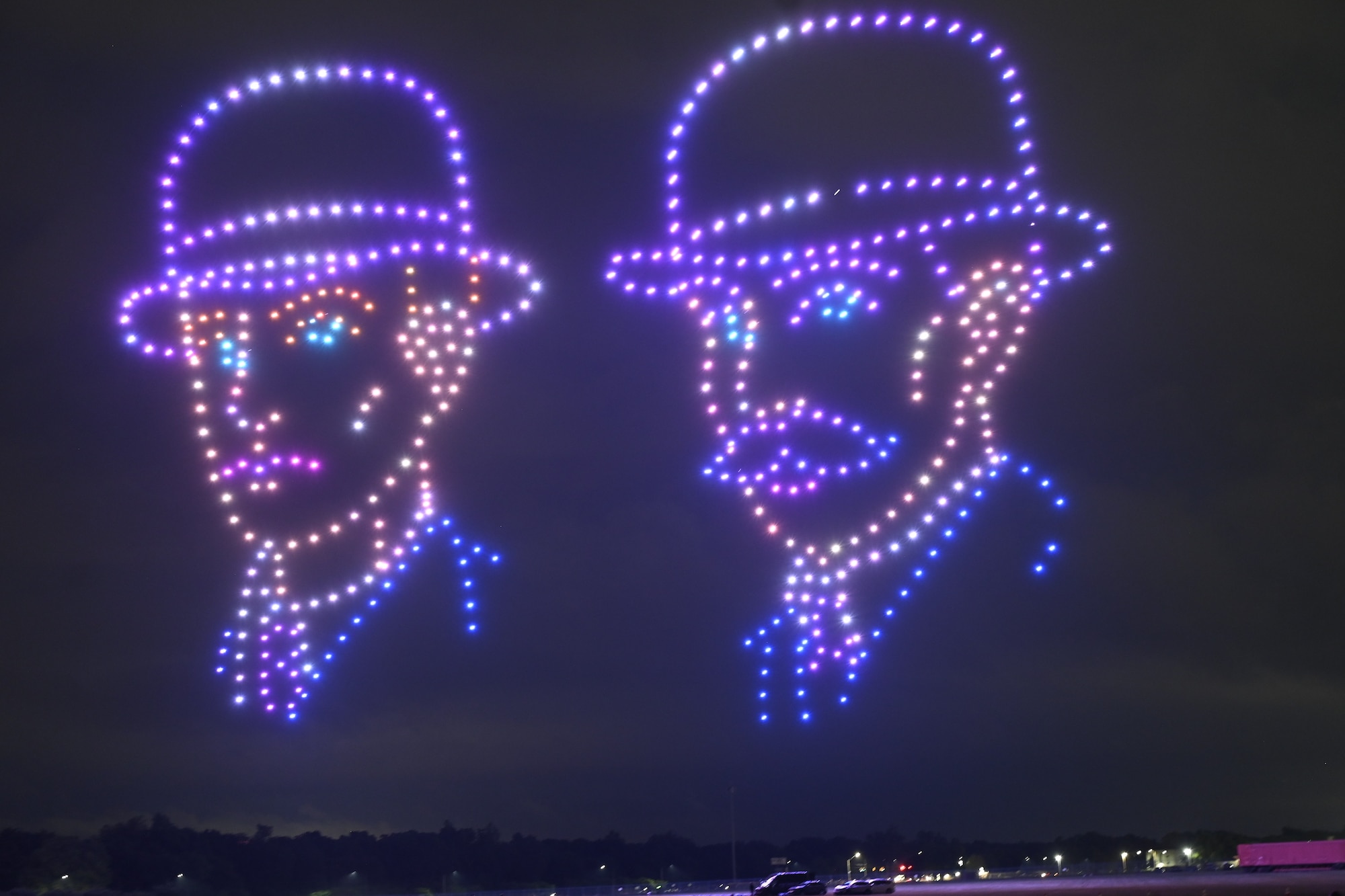 A formation of illuminated drones creates images of Orville and Wilbur Wright in the night sky during the Lights Over Dayton drone show at the National Museum of the U.S. Air Force.