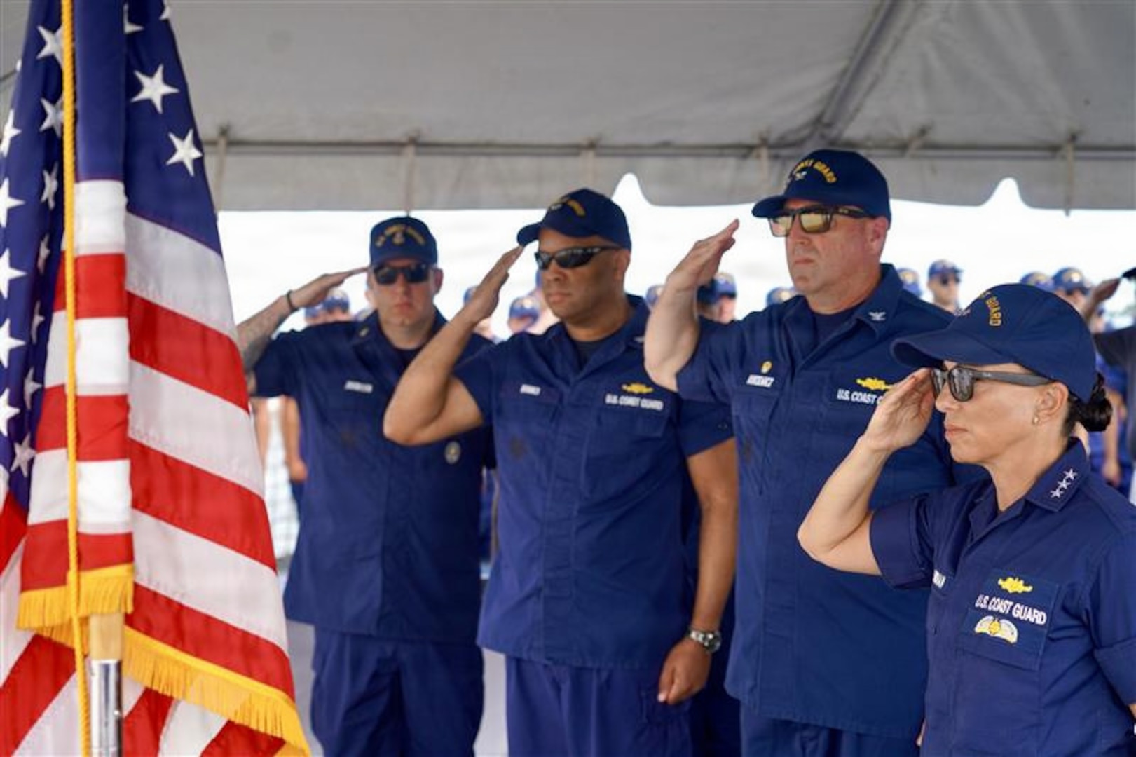 U.S. Coast Guard crewmembers aboard Coast Guard Cutter James, stand at parade rest during a change of command ceremony in Key West, Florida July 9, 2026. The James is one of four 418-foot Legend-class national security cutters homeported in Charleston, South Carolina, under U.S. Coast Guard Atlantic Area Command. (U.S. Coast Guard photo)