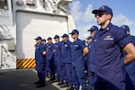 U.S. Coast Guard crewmembers aboard Coast Guard Cutter James, stand at parade rest during a change of command ceremony in Key West, Florida July 9, 2026. The James is one of four 418-foot Legend-class national security cutters homeported in Charleston, South Carolina, under U.S. Coast Guard Atlantic Area Command. (U.S. Coast Guard photo)