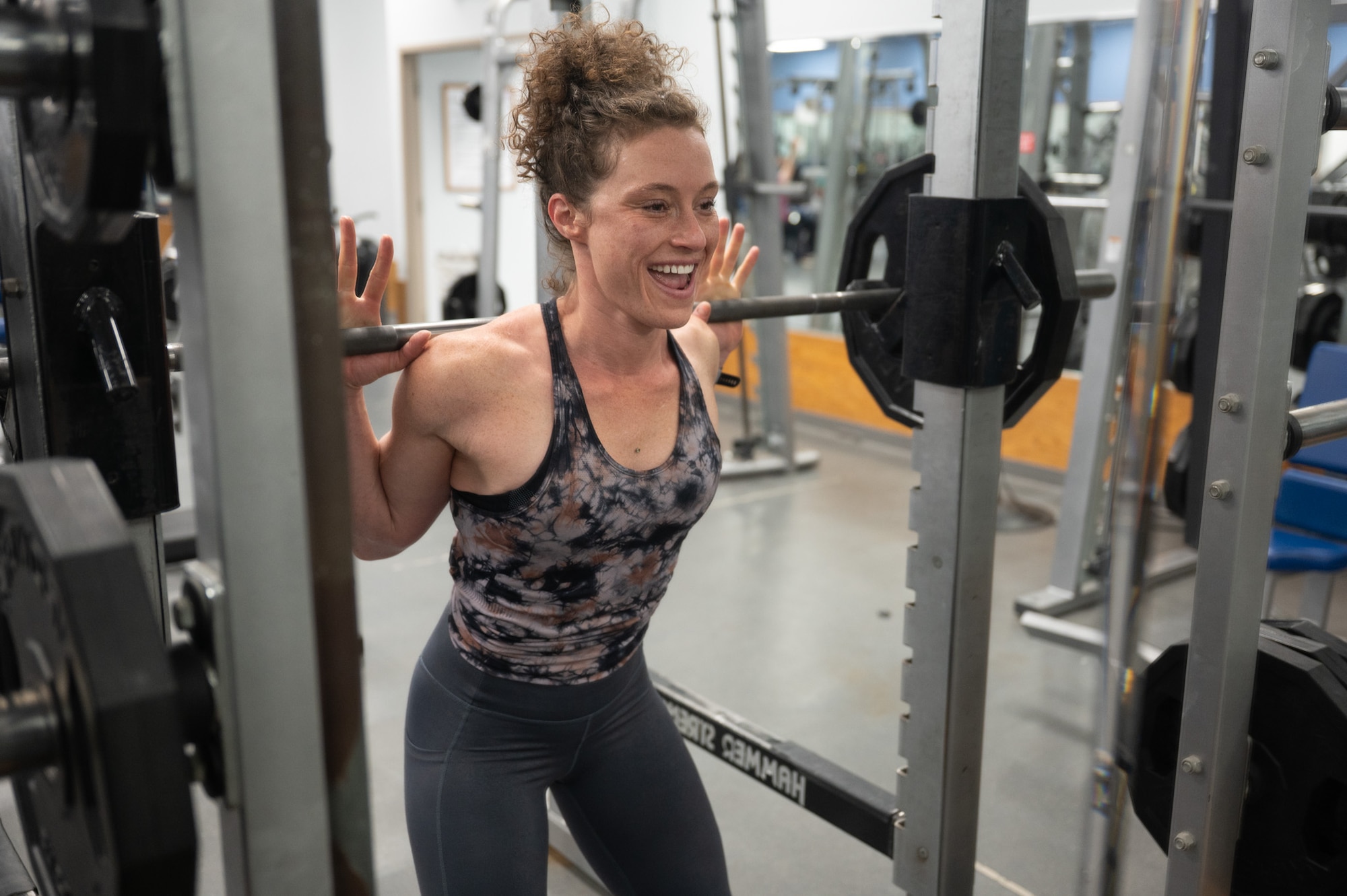 Jill Cangealose, personal trainer, performs a squat at the Mcadoo Fitness center on Minot Air Force Base, North Dakota, June 10, 2026. Jill led fitness classes that reached hundreds of Airmen spouses and community members.