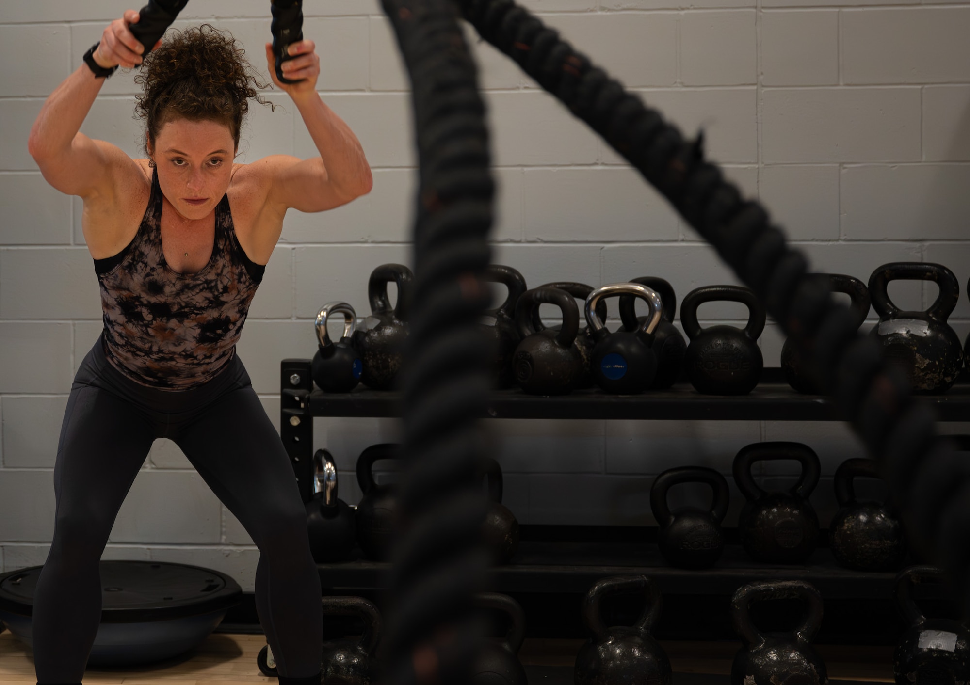 Jill Cangealose, personal trainer, performs a battle reop exercise at Minot Air Force Base, North Dakota, June 10, 2026. Jill helped Airmen improve strength, mobility, nutrition and overall fitness to support mission readiness.