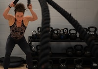 Jill Cangealose, personal trainer, performs a battle reop exercise at Minot Air Force Base, North Dakota, June 10, 2026. Jill helped Airmen improve strength, mobility, nutrition and overall fitness to support mission readiness.