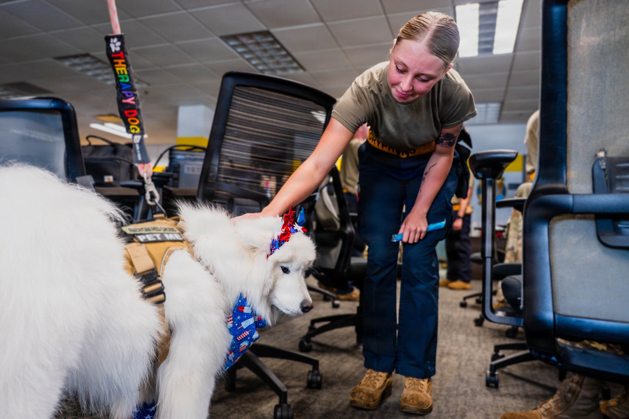 A photo of an Airman petting a therapy dog.